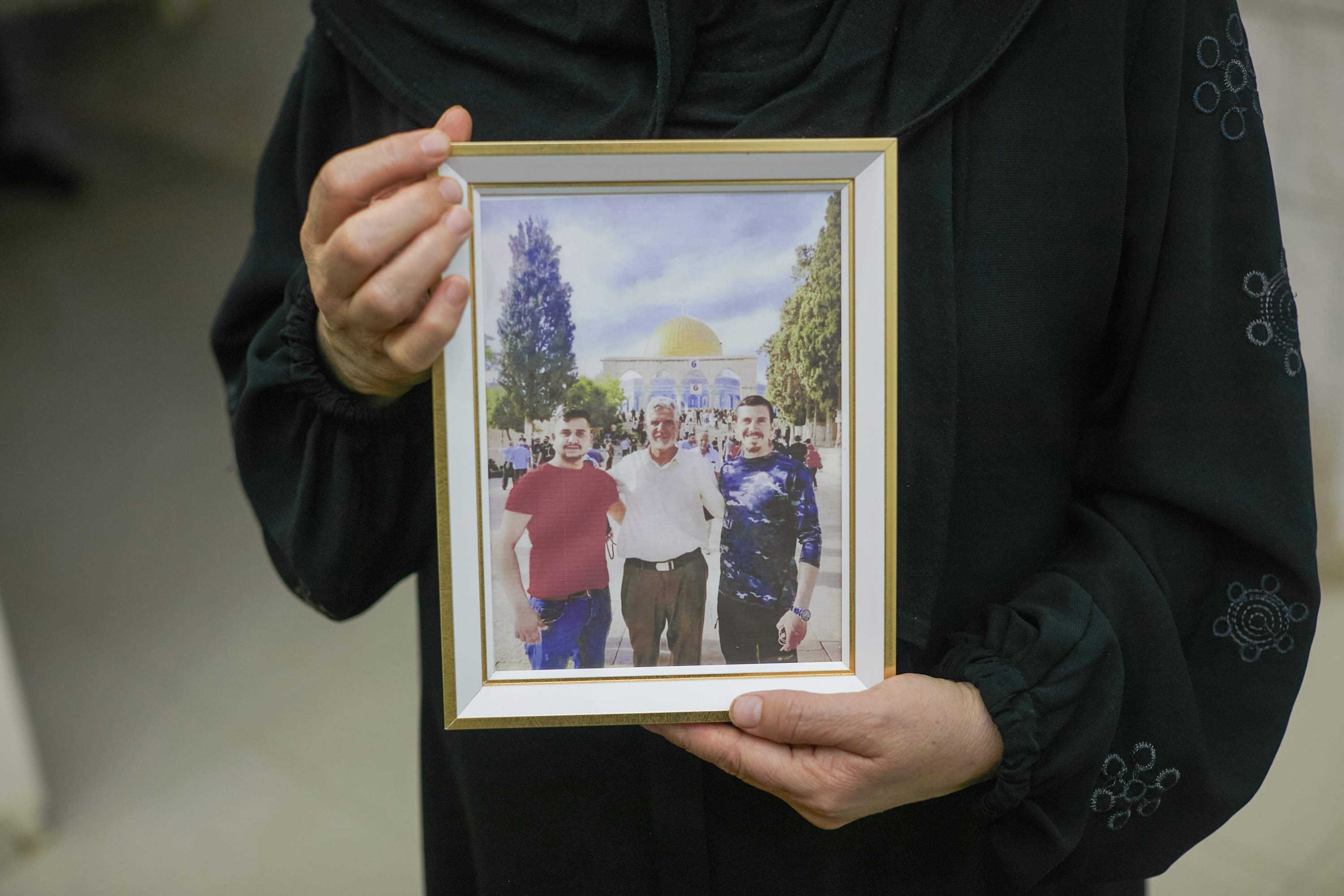 Amal holds photo of her children