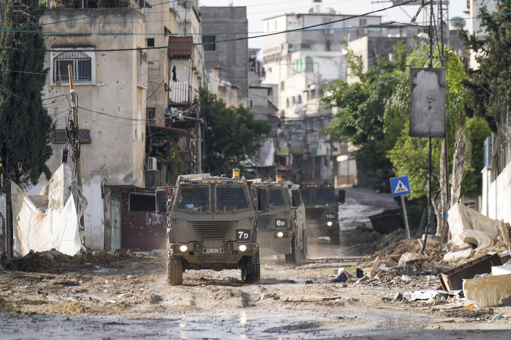 Israeli military vehicles are seen in the town of Tulkarem, West Bank, Wednesday, Nov. 22, 2023. The Palestinian Health Ministry said the Israeli military killed six Palestinians, five of them militants, during a raid that sparked an hourslong firefight with militants in a flashpoint refugee camp in the northern city of Tulkarem. (AP Photo/Majdi Mohammed)