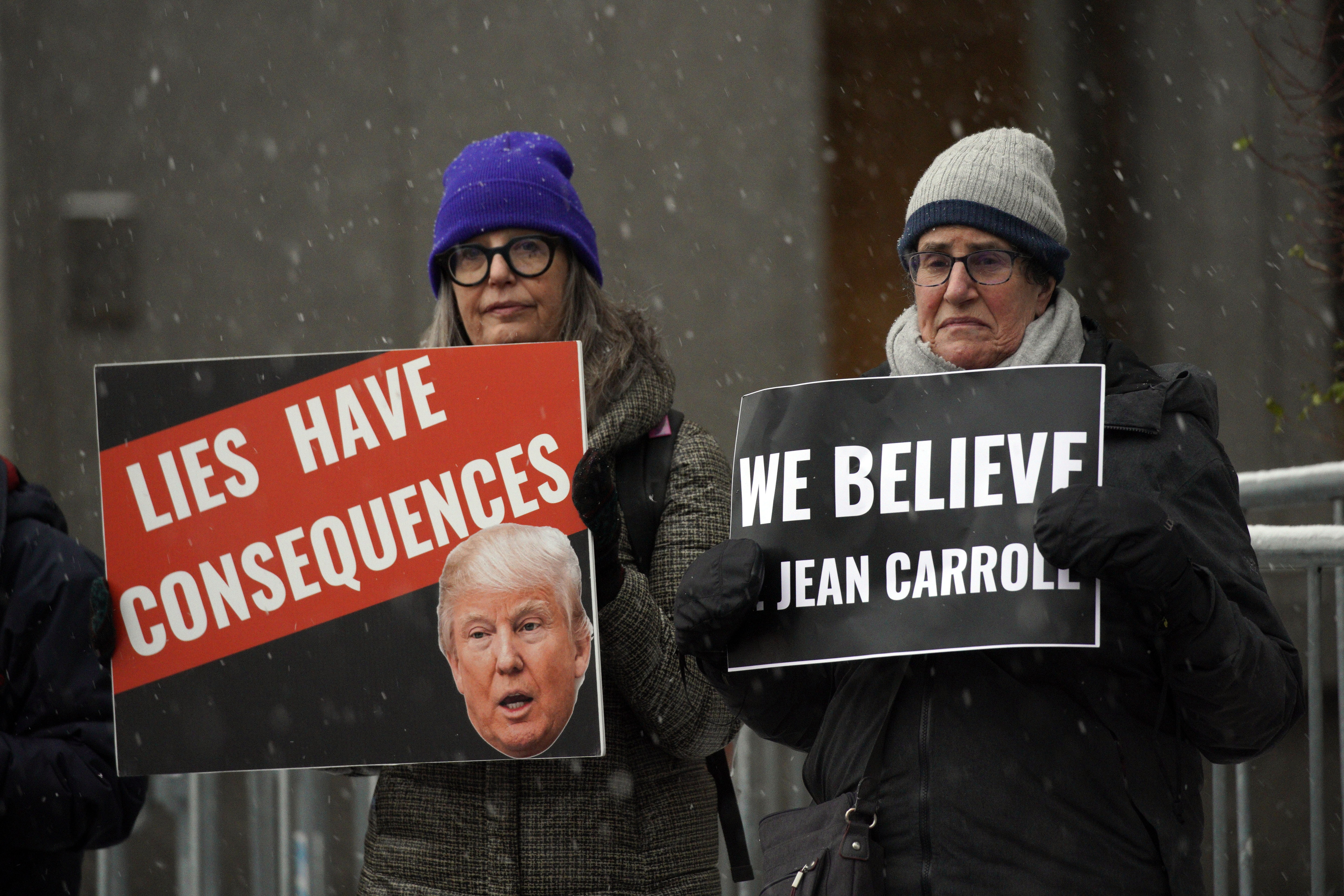 People carry anti-Trump signs outside federal court,