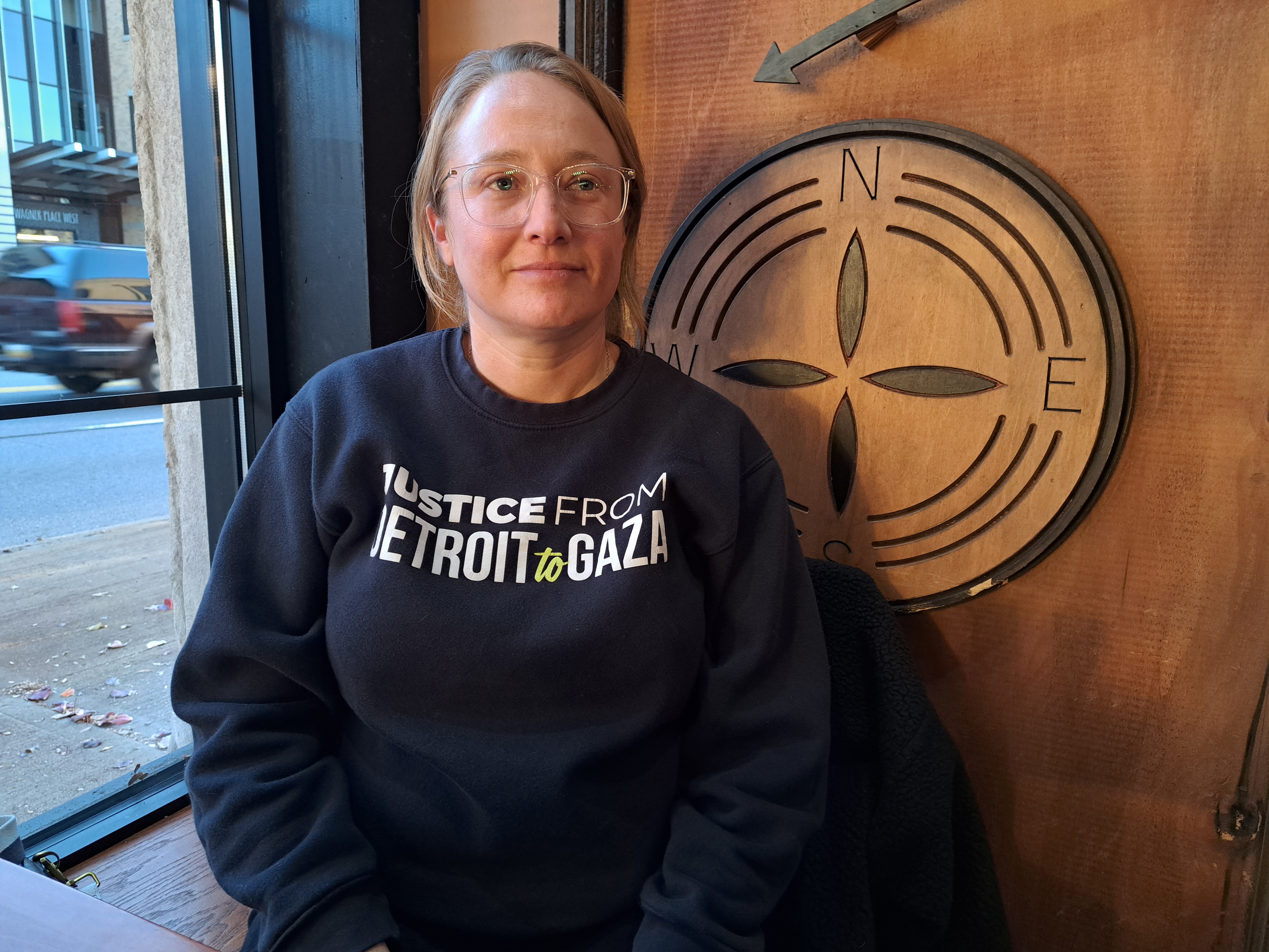 Dana Kornberg, in a black sweater that reads: "Justice from Detroit to Gaza".