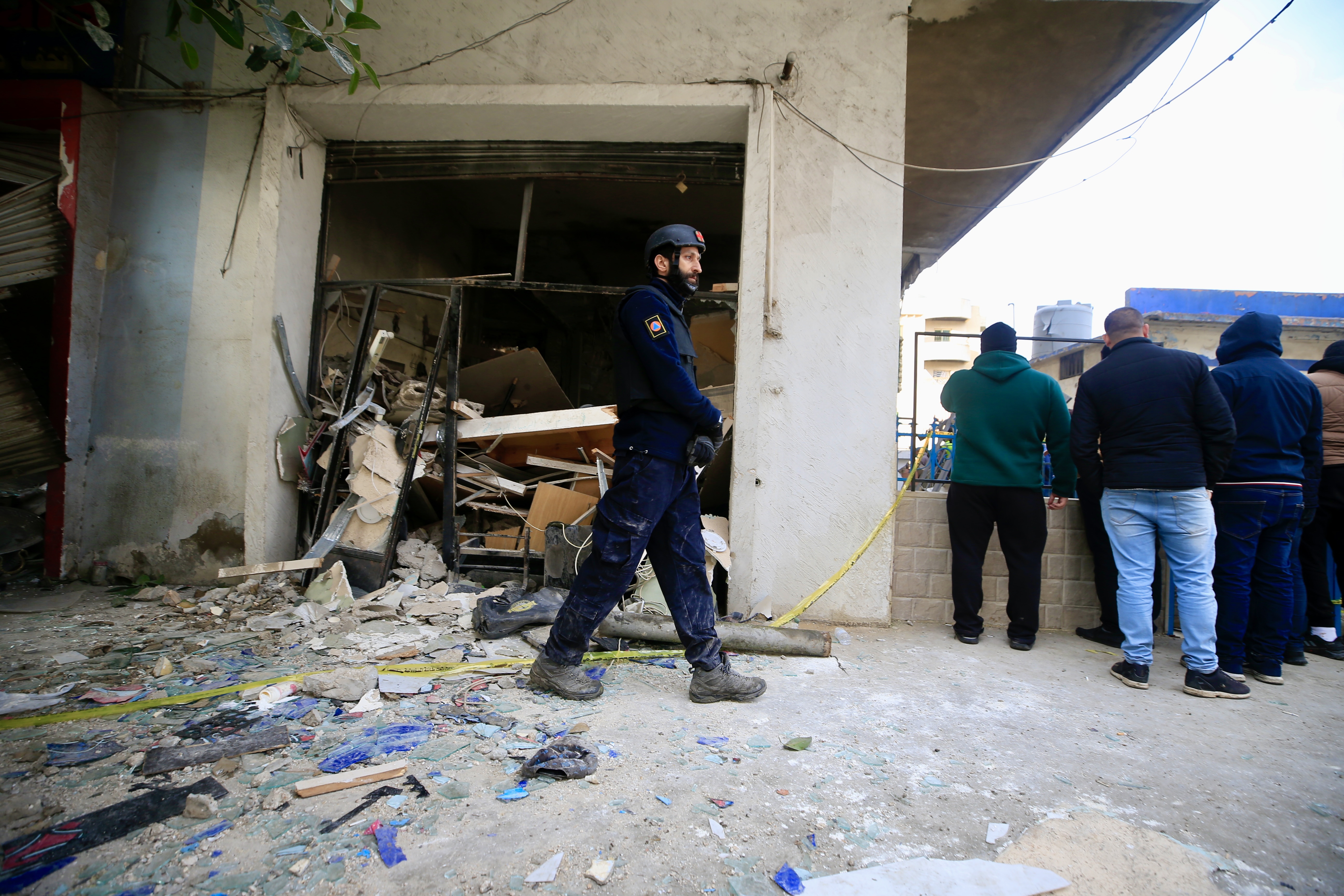 Rescuers work at a damaged buidling following an Israeli military strike in Nabatiyeh