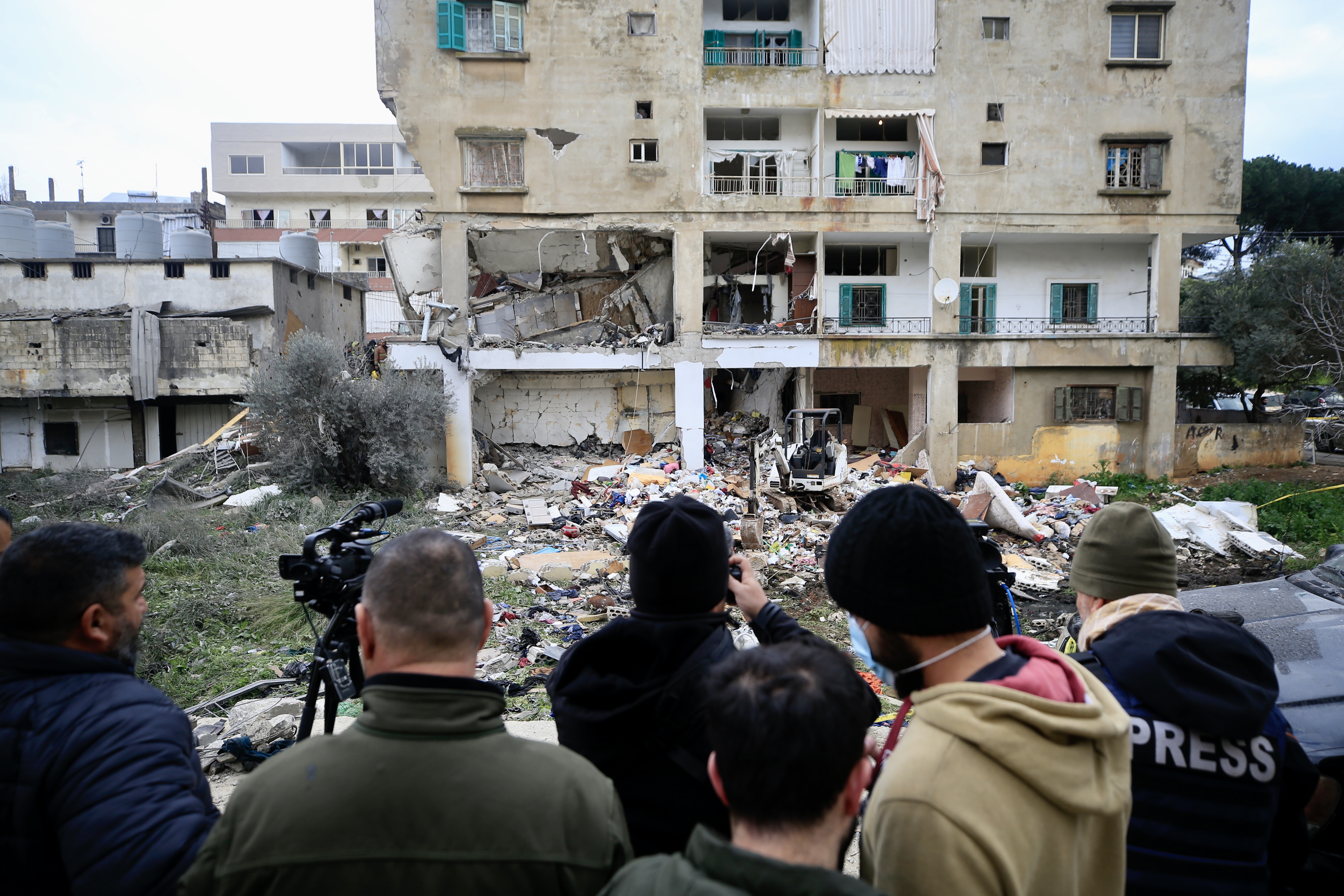 Rescuers work at a damaged buidling following an Israeli military strike in Nabatiyeh