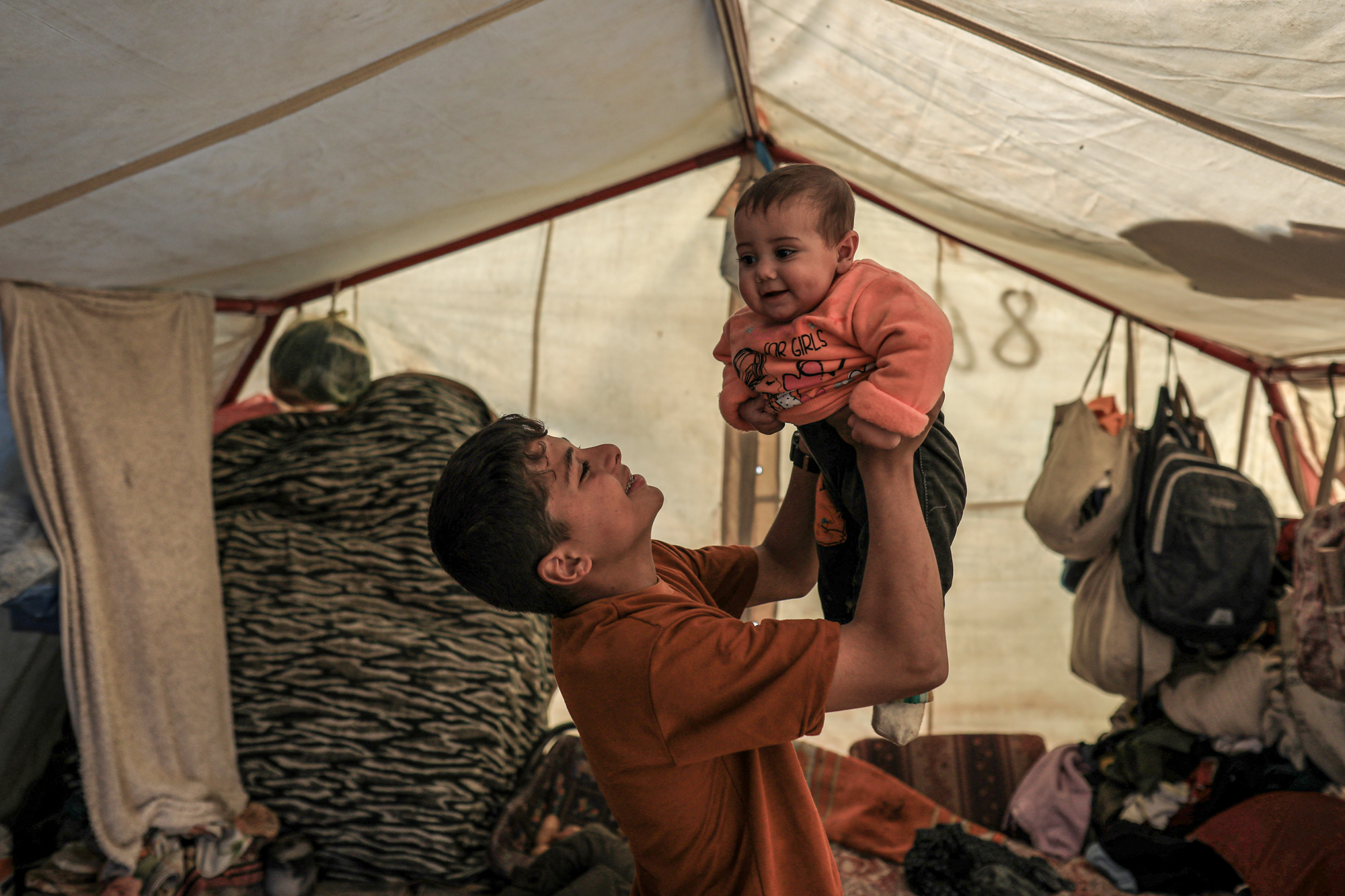 Mohamed plays with Toleen in their tent
