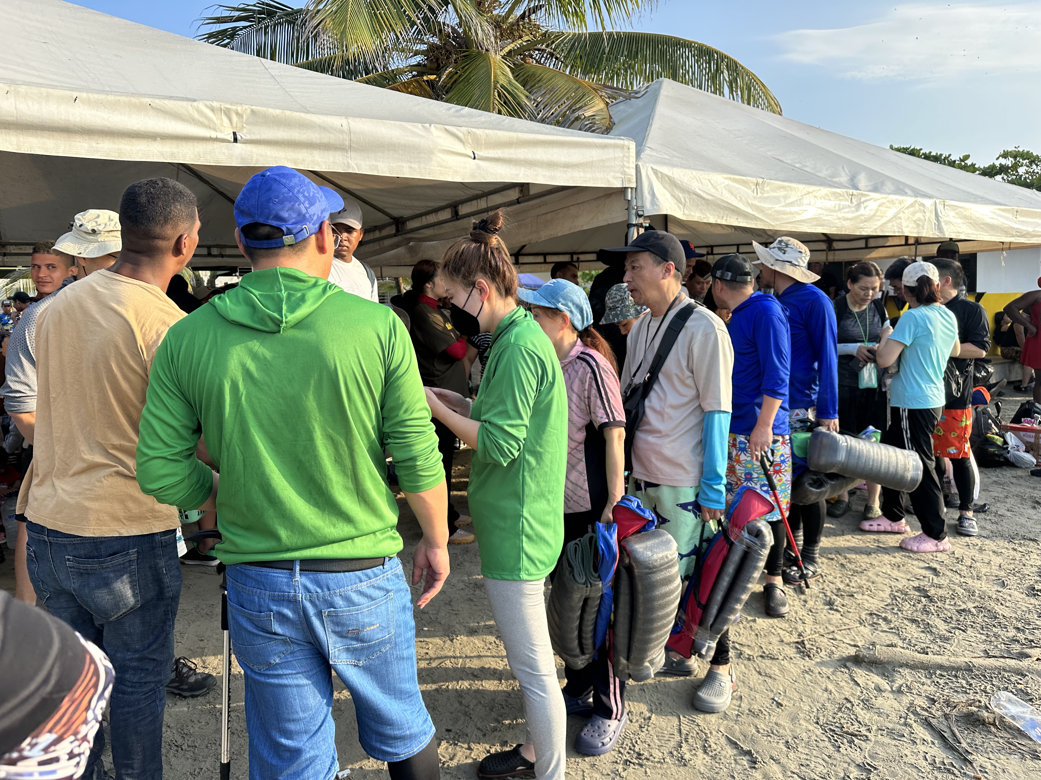 A line of Chinese migrants waiting to depart on boats in Necoclí-