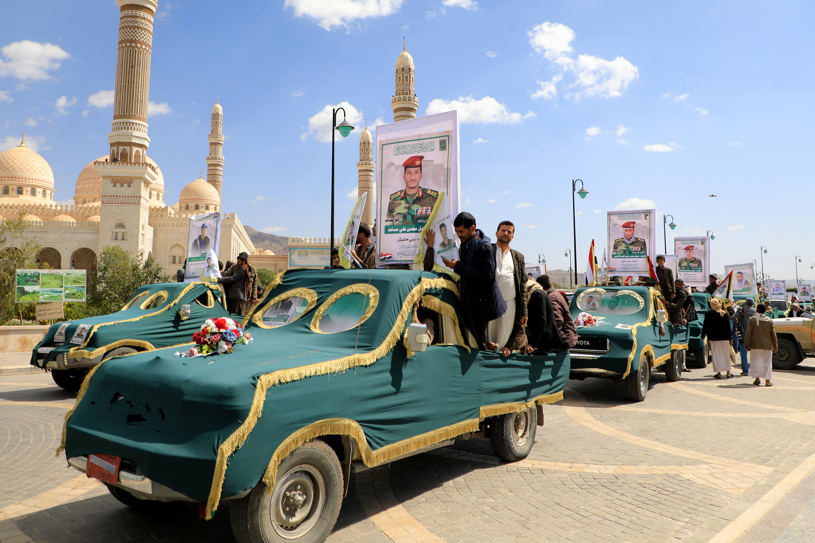 Vehicles covered in green fabric, carrying the coffins of Yemeni Huthi rebels killed in recent US-led strikes, drive near Sanaa's Al-Saleh mosque during a funeral ceremony on February 10, 2024. - The United States military confirmed on February 8 its forces conducted multiple strikes against Huthi missile systems as the Yemen-based rebel group prepared to launch attacks that threatened US Navy and merchant ships. (Photo by MOHAMMED HUWAIS / AFP)