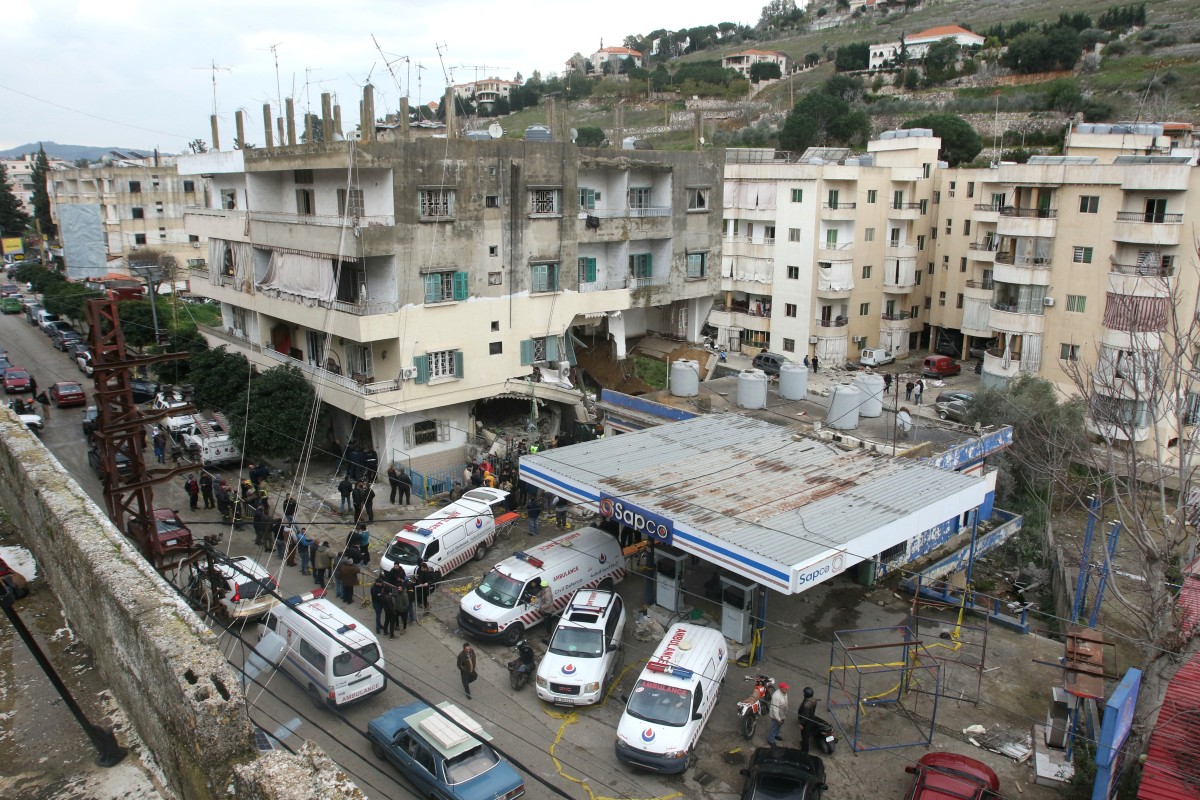 Rescuers work at a damaged buidling following an Israeli military strike in Nabatiyeh