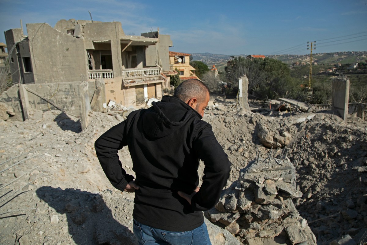 Residents and rescuers check the destruction after an overnight Israeli bombardment in the southern Lebanese village of Kafra