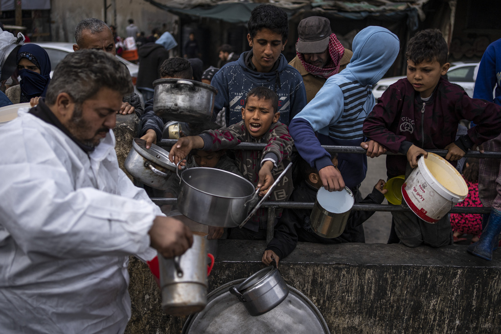 Palestinians line up for food in Rafah, Gaza Strip