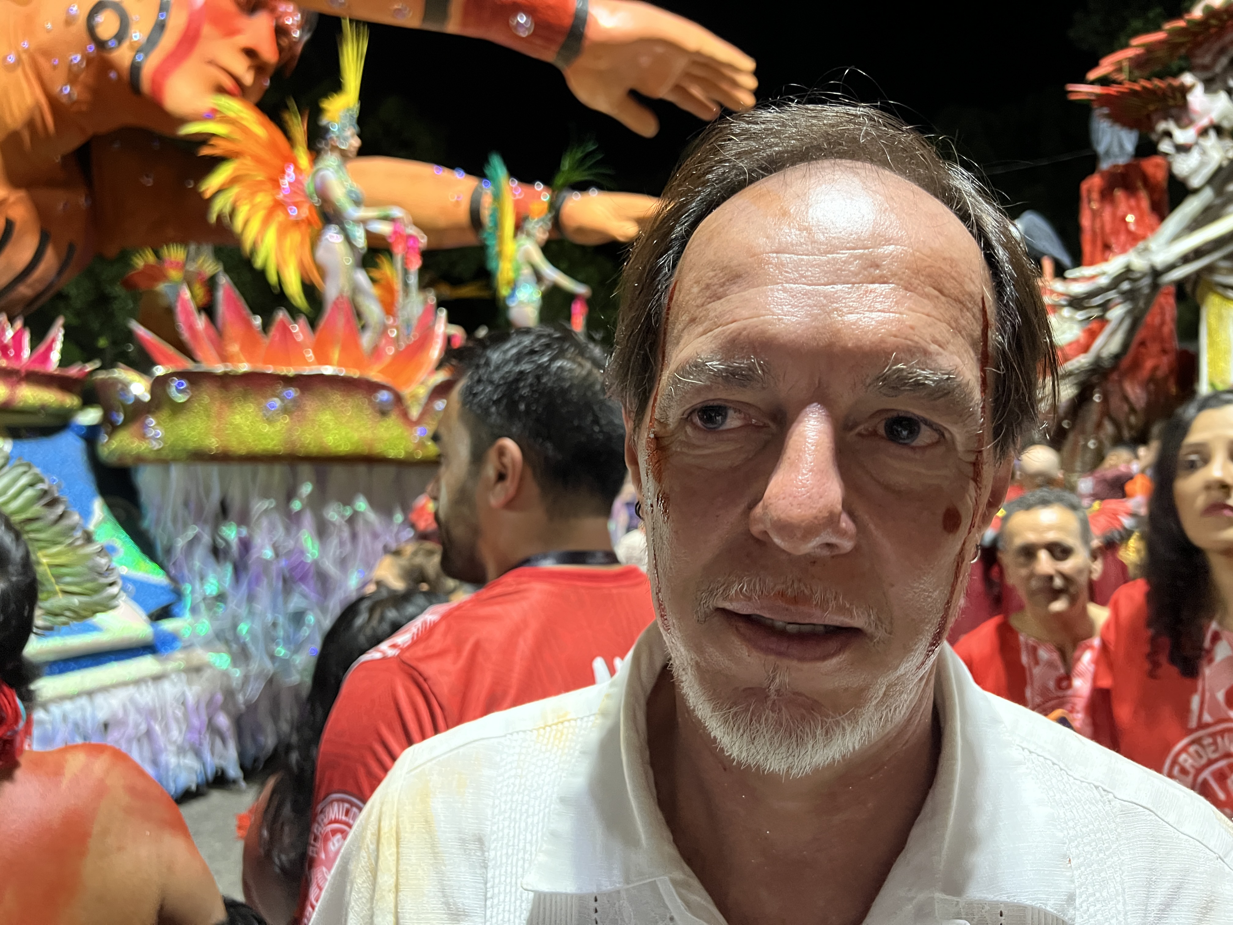 Marcos Wesley stands in front of a parade float at night in Rio de Janeiro.
