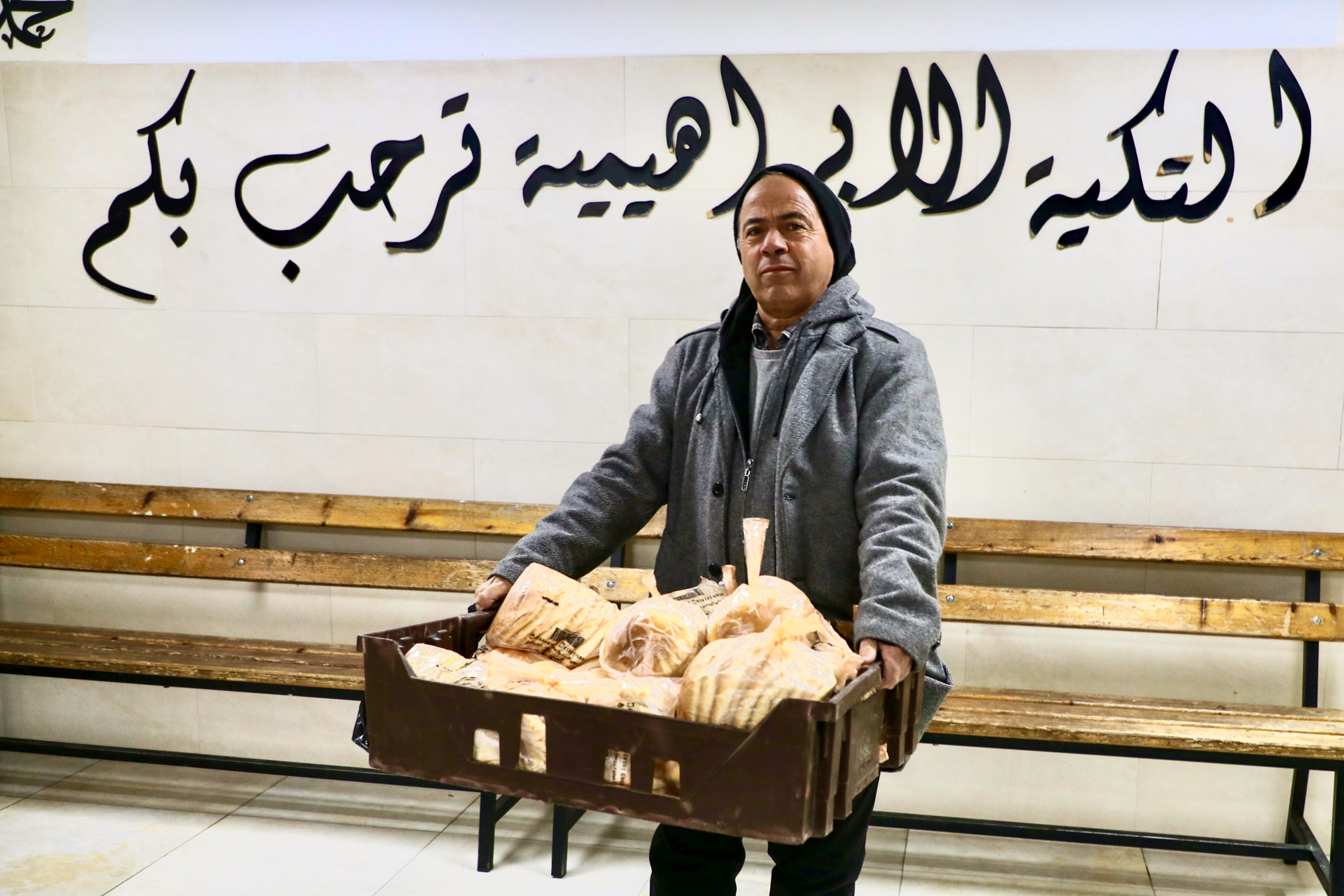 A man carrying a basket of bread