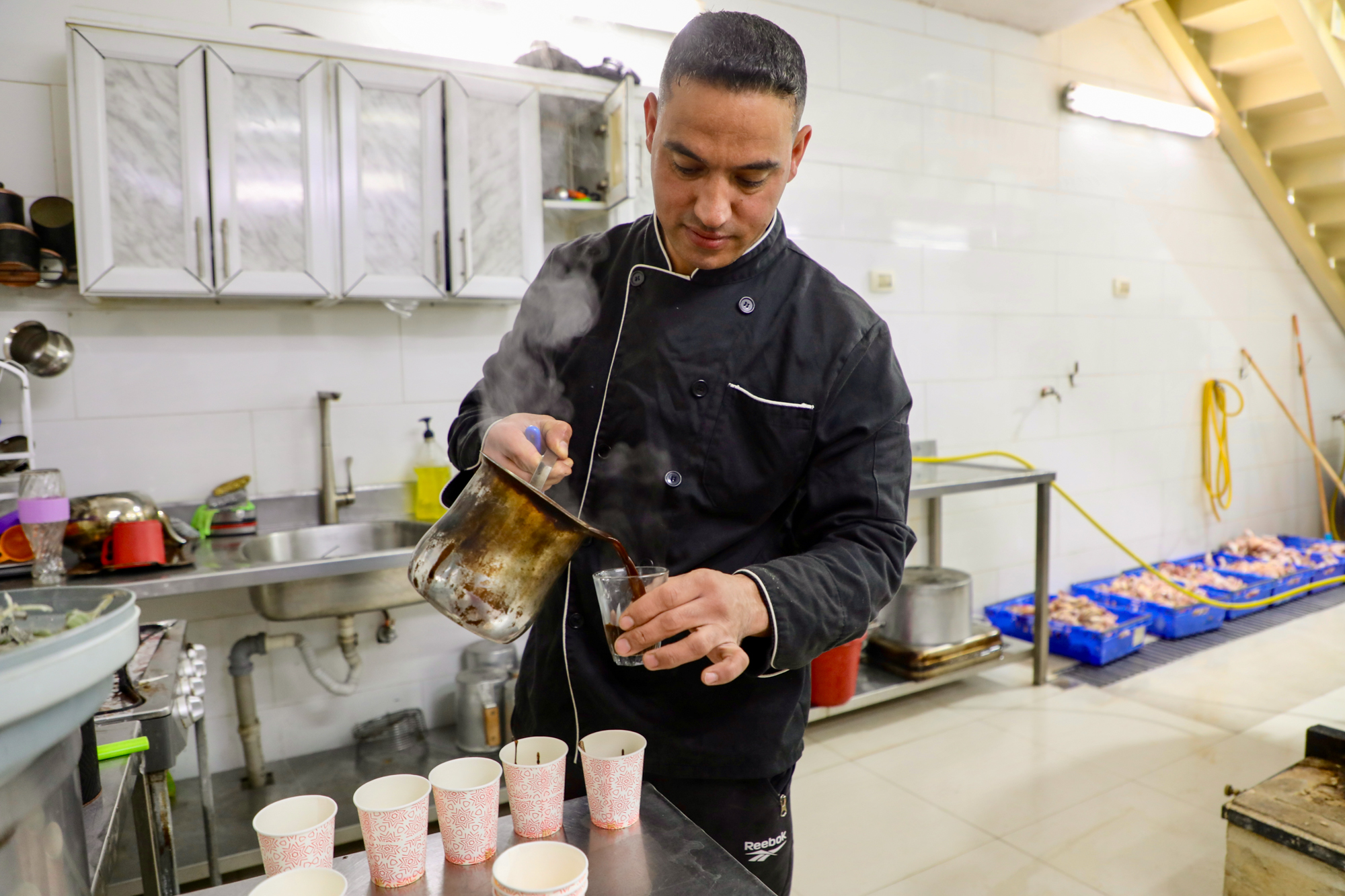 A chef preparing tea for the team