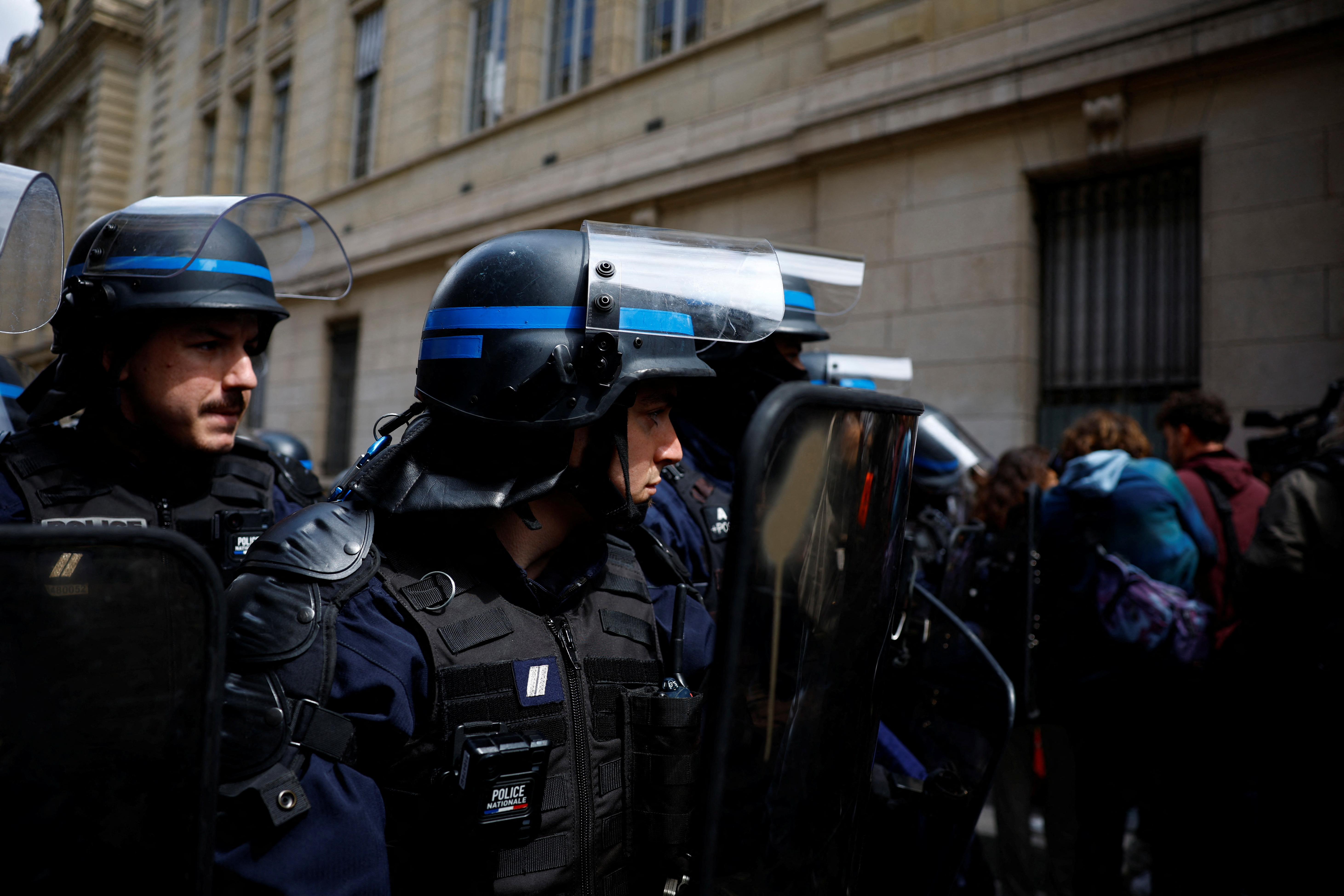 French police stand on position as students block the entrance of the Sorbonne University