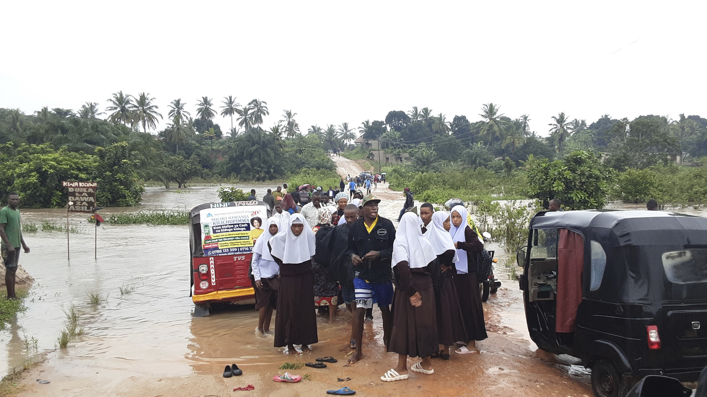 Schoolchildren stranded on a damaged River Zingiziwa bridge in Dar Esalaam, Tanzania
