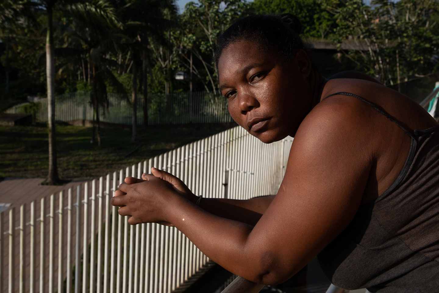 Consuela Manyoma leans against a railing outside the Crystal Coliseum