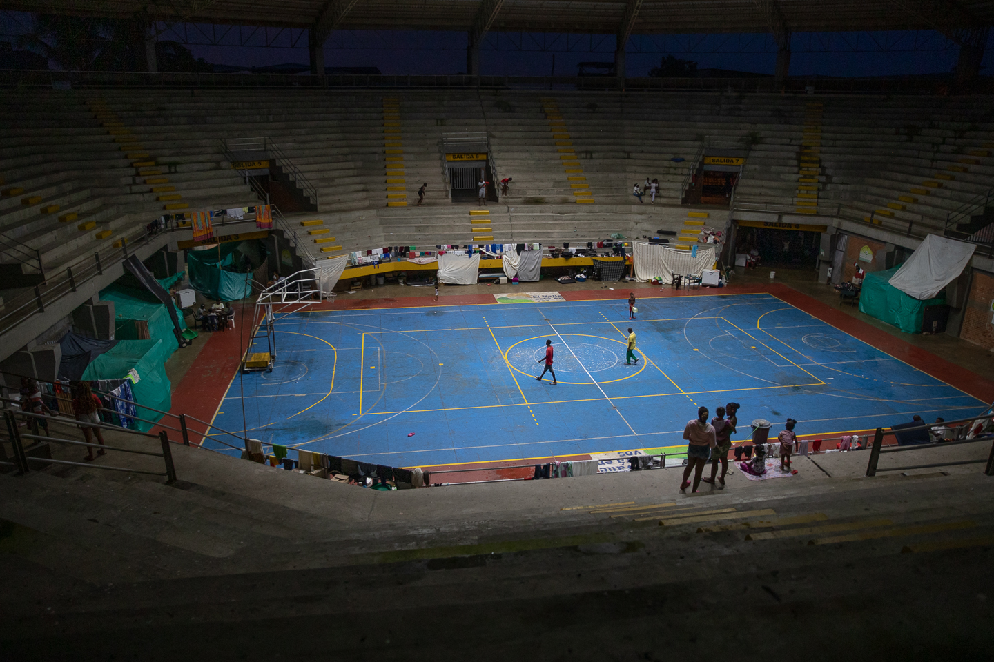 A view of the inside of Crystal Coliseum, with a blue basketball court surrounded by concrete stands
