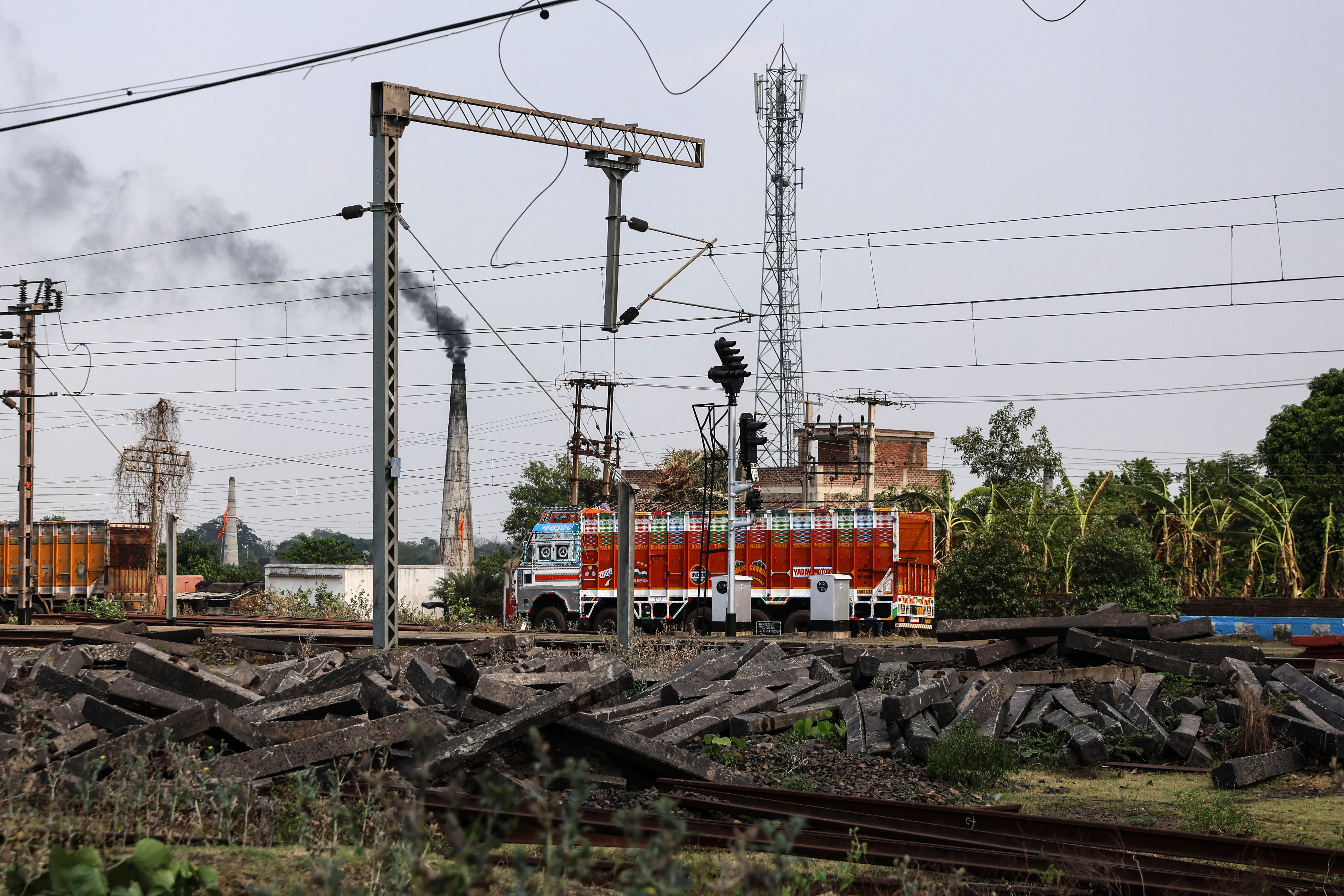 A truck drives past a coal siding rail track near the railway station in Barabani, West Bengal