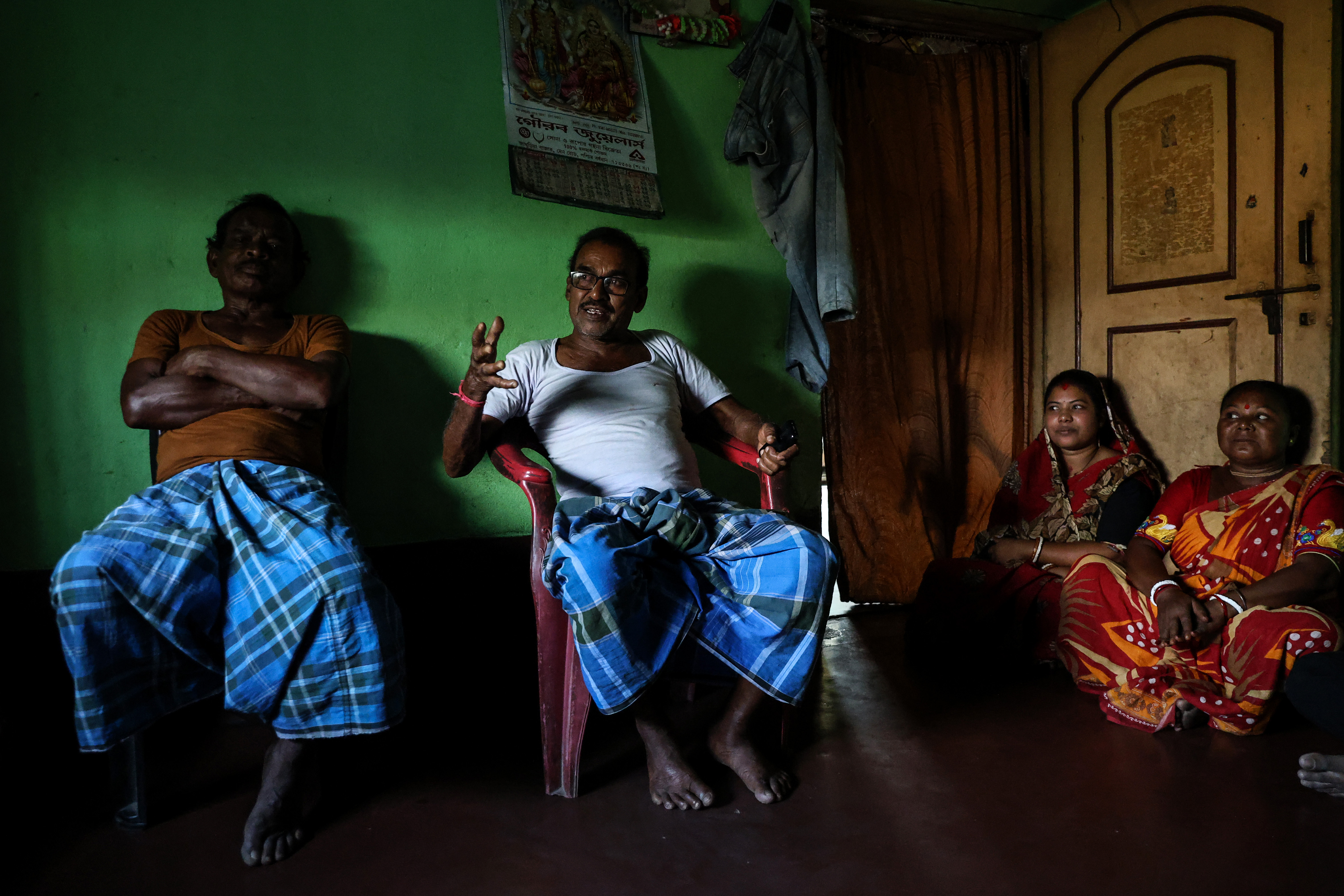 Manik Bauri, 71, second left, Asha Bauri, 30, third left, and Madhivi Bauri, 45, right, in their house in Rakhakura, West Bengal