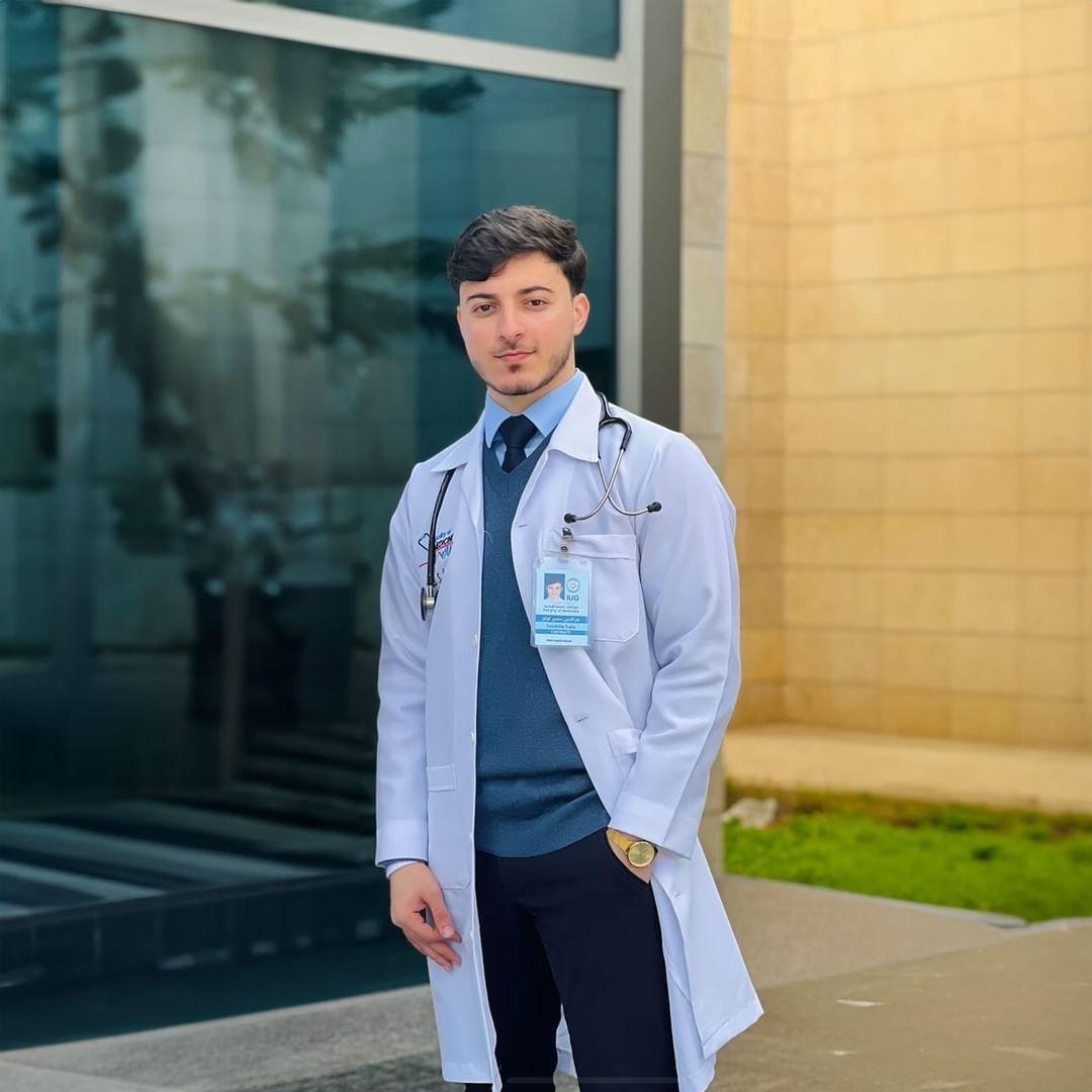 Ezzedine Lulu stands in front of a hospital in Gaza [courtesy of Lulu/Al Jazeera]