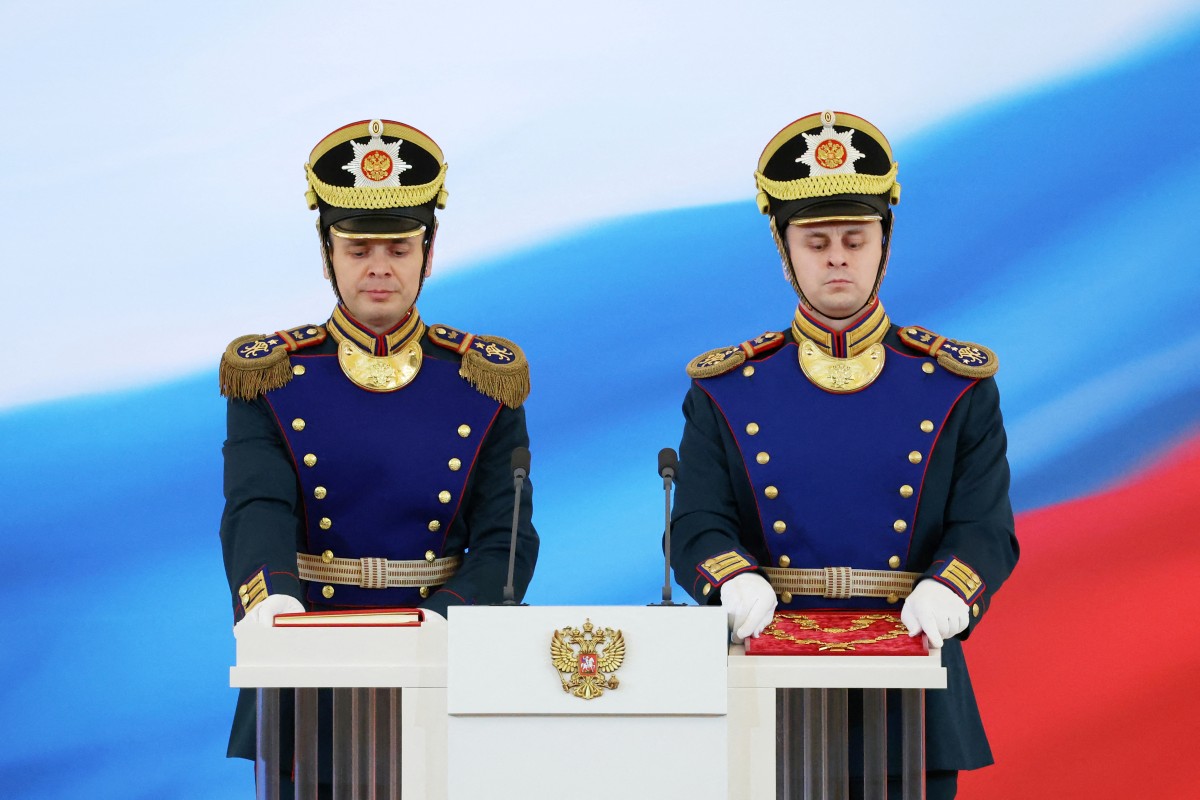 A honour guard carries the Constitution of the Russian Federation and the President's sign