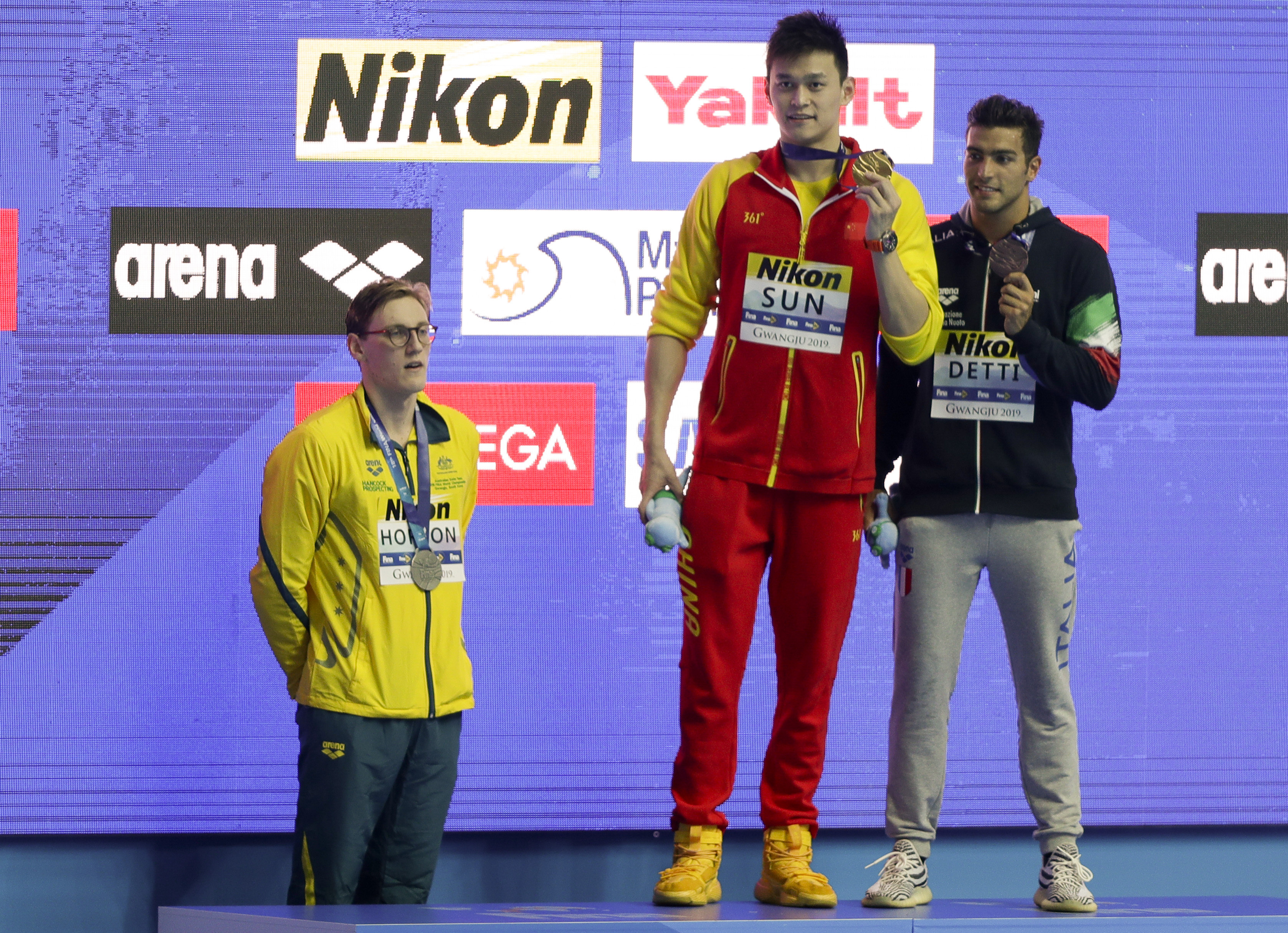 Swimmers on podium.