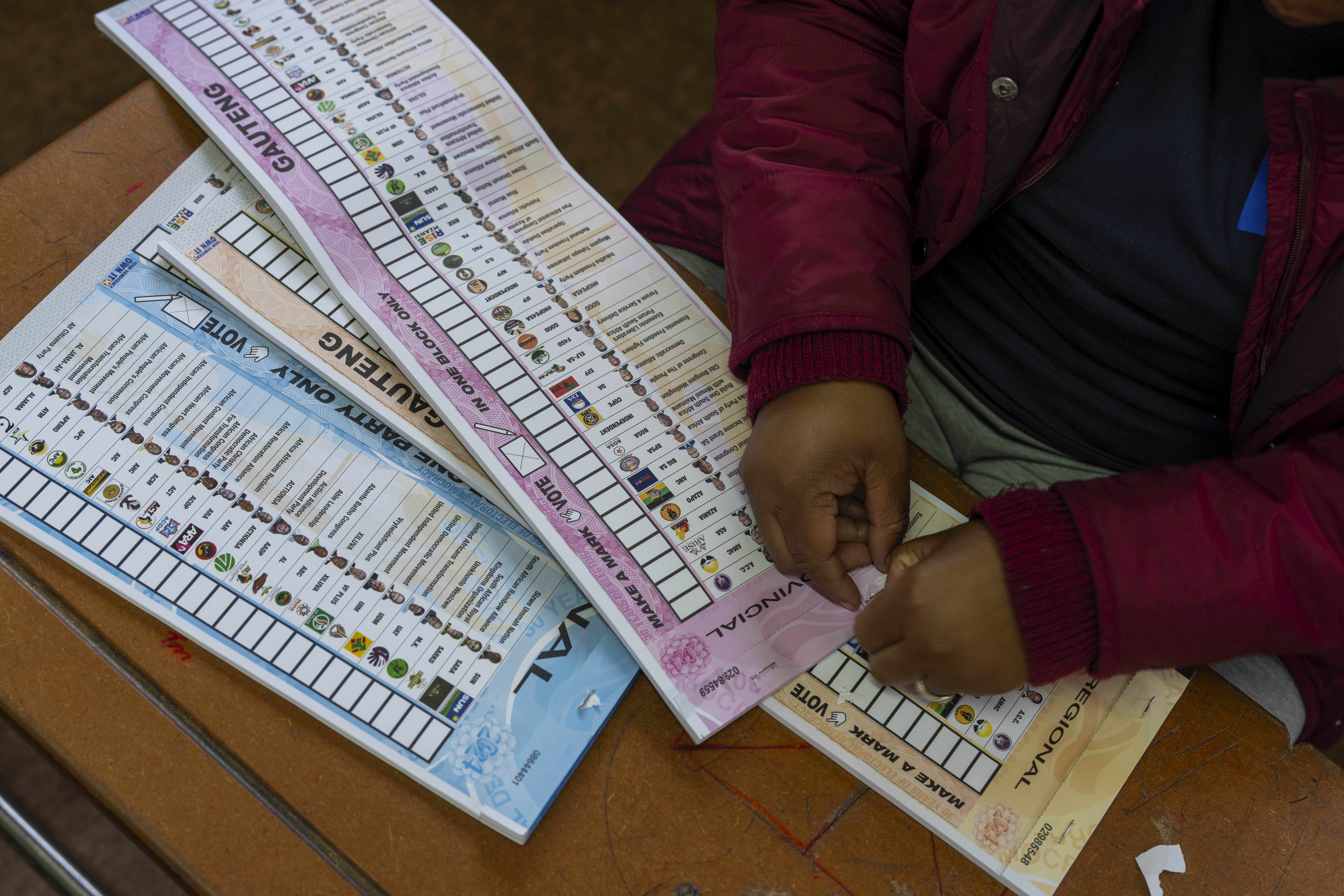 An election official prepares the ballots