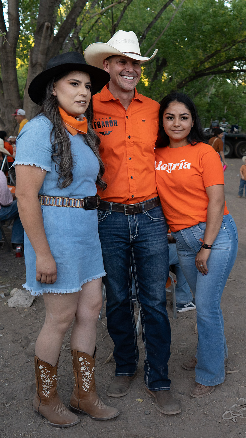 Bryan LeBaron poses with two women as a third takes a photo with her phone.
