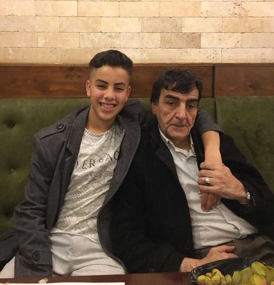 Taha Mahamid, 15, and his father Ibrahim Mahamid pose in a photo at a restaurant in the West Bank. Both were shot and killed by Israeli forces.