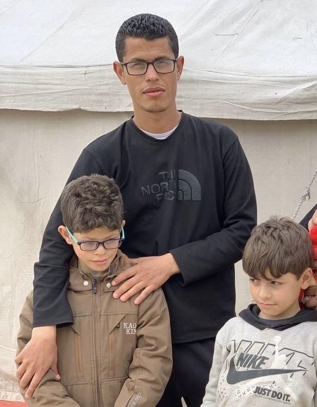 Khader Al Belbesy with his two sons during the war