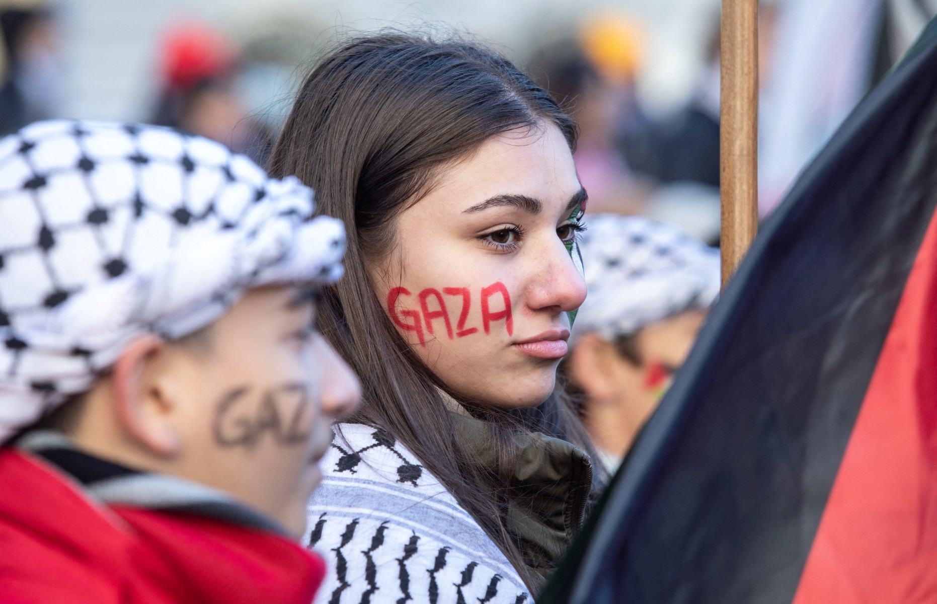Demonstrators in support of Palestinians wear "Gaza" painted on their faces during a rally to call for a ceasefire, at Dorchester Square in Montreal, Quebec, Canada, on November 18, 2023. Israel has vowed to destroy Hamas in response to the October 7 attacks which Israeli officials say killed about 1,200 people, most of them civilians in southern Israel, and saw about 240 people taken hostage. The Hamas-run health ministry in Gaza says the death toll from the military offensive has since killed 12,000 people, including 5,000 children. (Photo by Alexis Aubin / AFP) / ALTERNATE CROP - ALTERNATE CROP