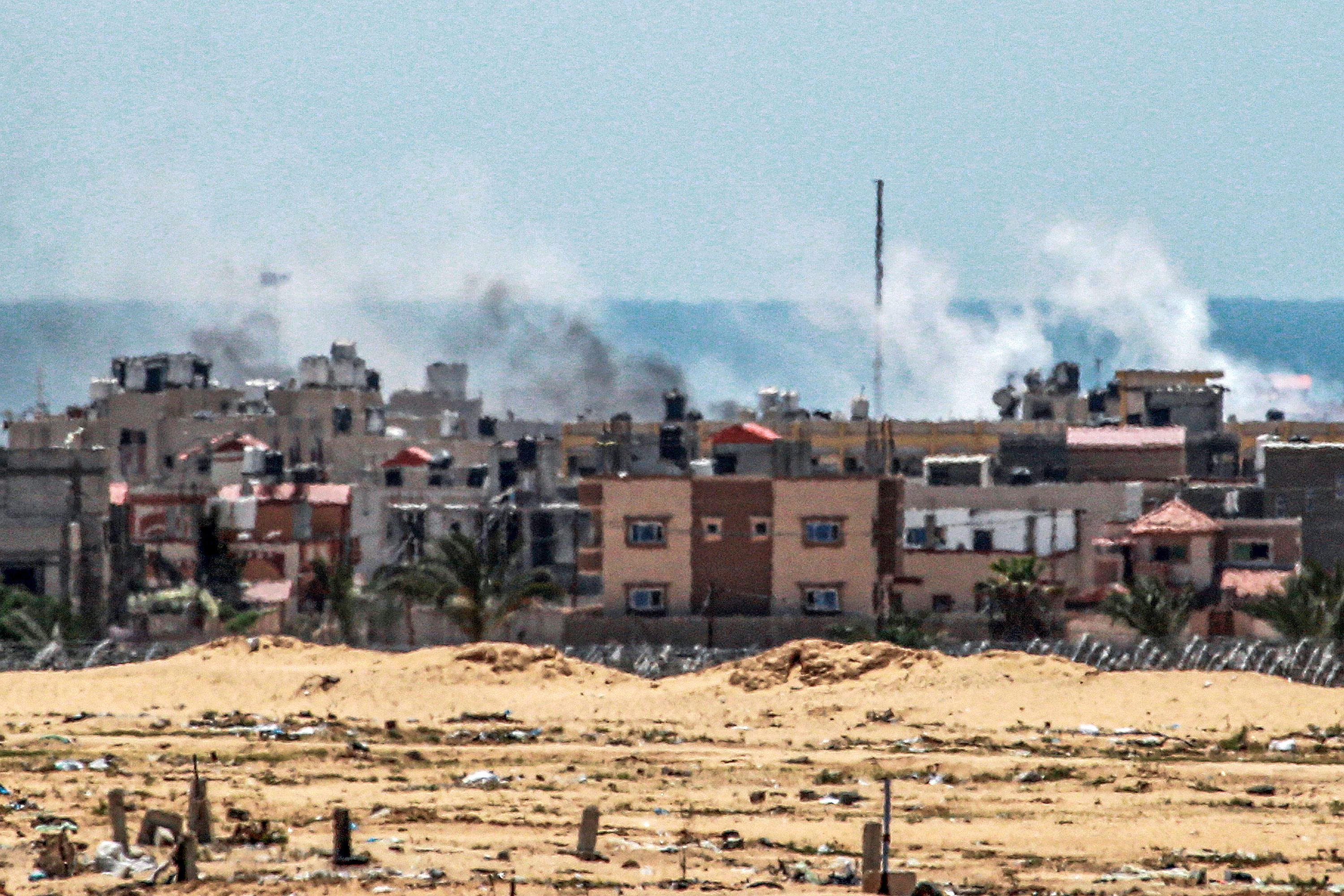 This picture shows smoke plumes billowing during ongoing battles in the Sultan neighbourhood in Rafah. [Bashar Taleb/AFP]