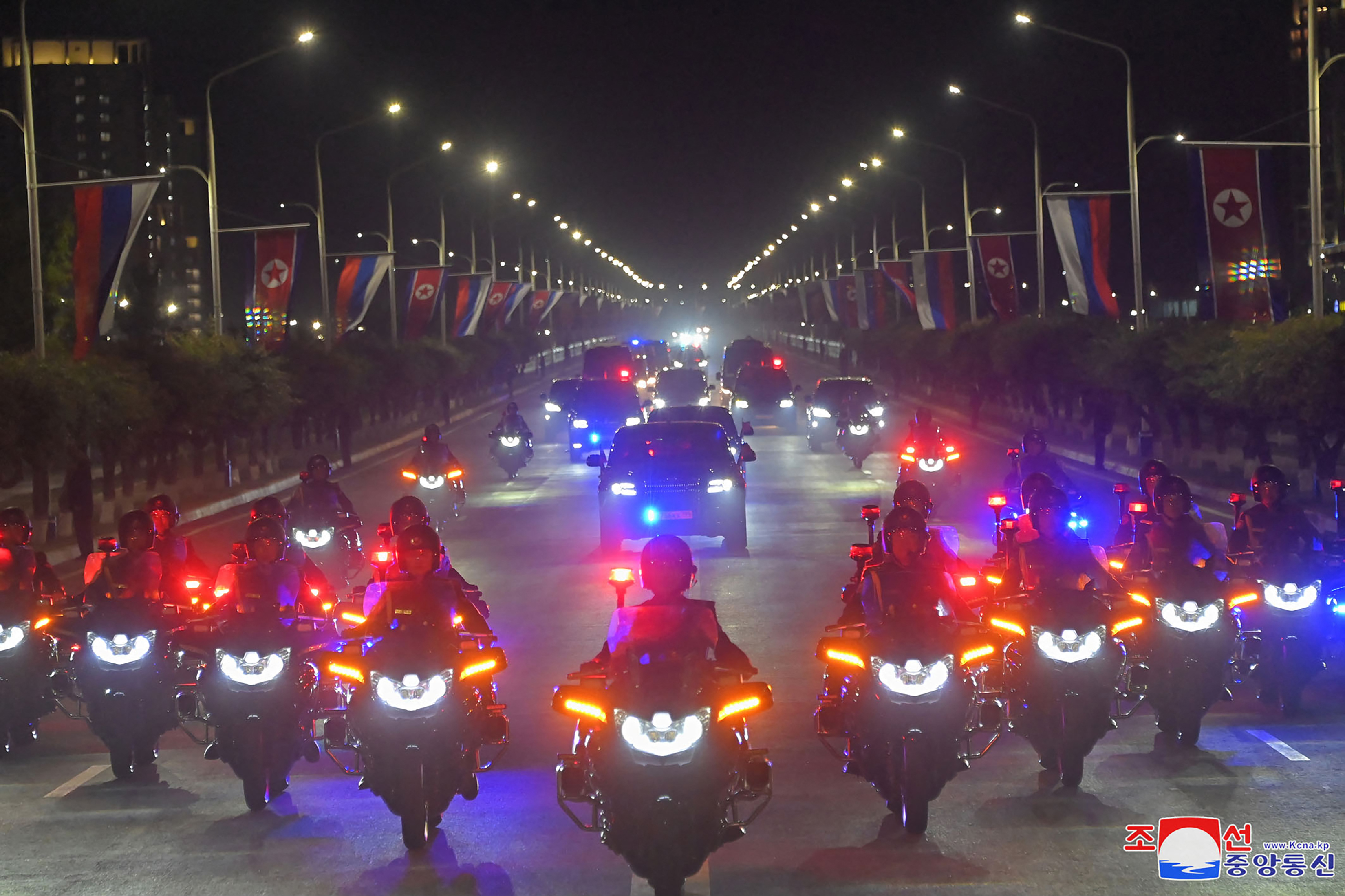 Putin and Kim's motorcade led by outriders in formation. It's night time so the vehicles have their lights on