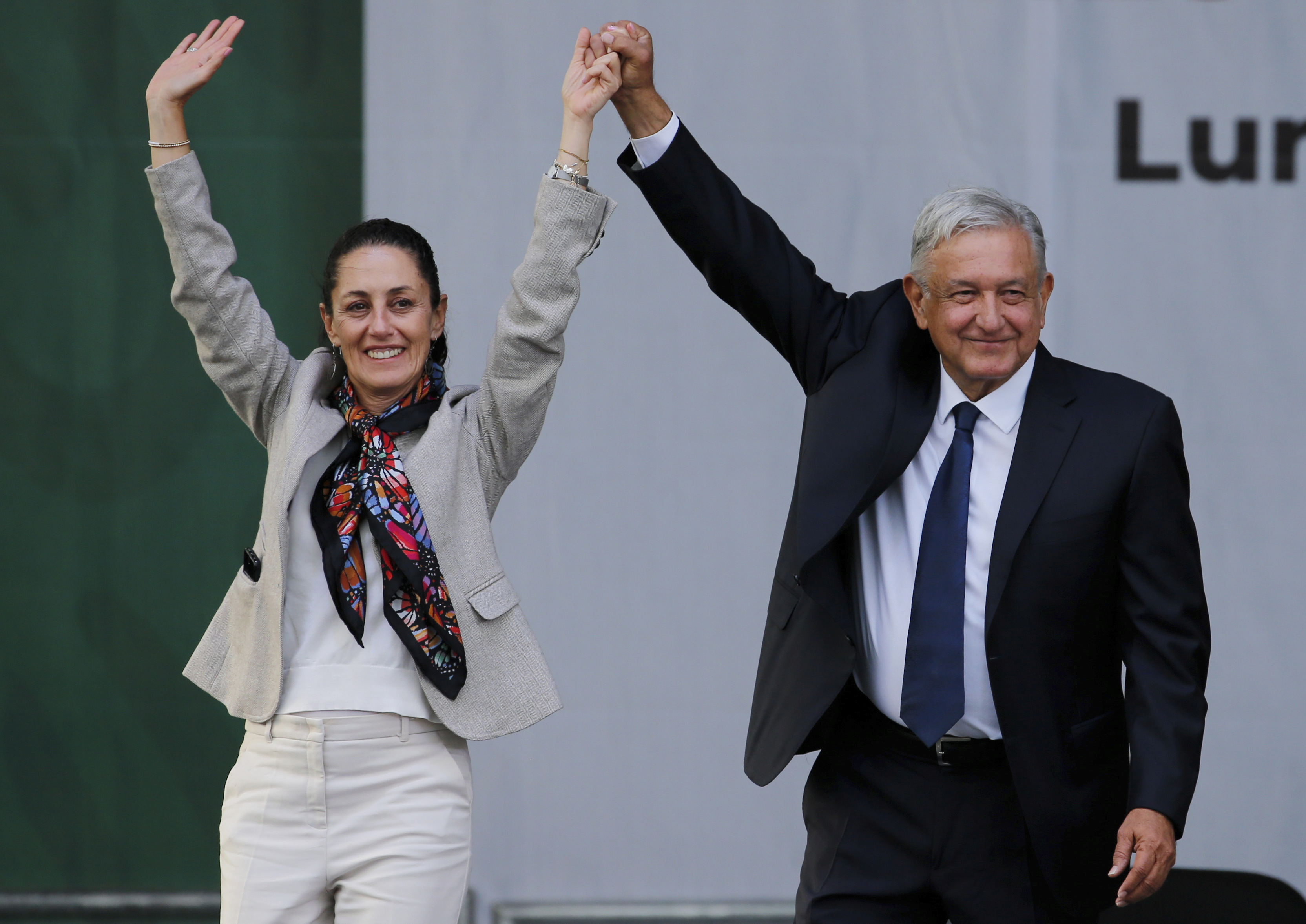 FILE - Mexico's President Andres Manuel Lopez Obrador, right, and Mayor Claudia Sheinbaum, greet supporters at a rally in Mexico City's main square, the Zocalo, July 1, 2019. Immigration is not part of Mexico's political conversation as the country gears up for its presidential vote on June 2. (AP Photo/Fernando Llano, File)