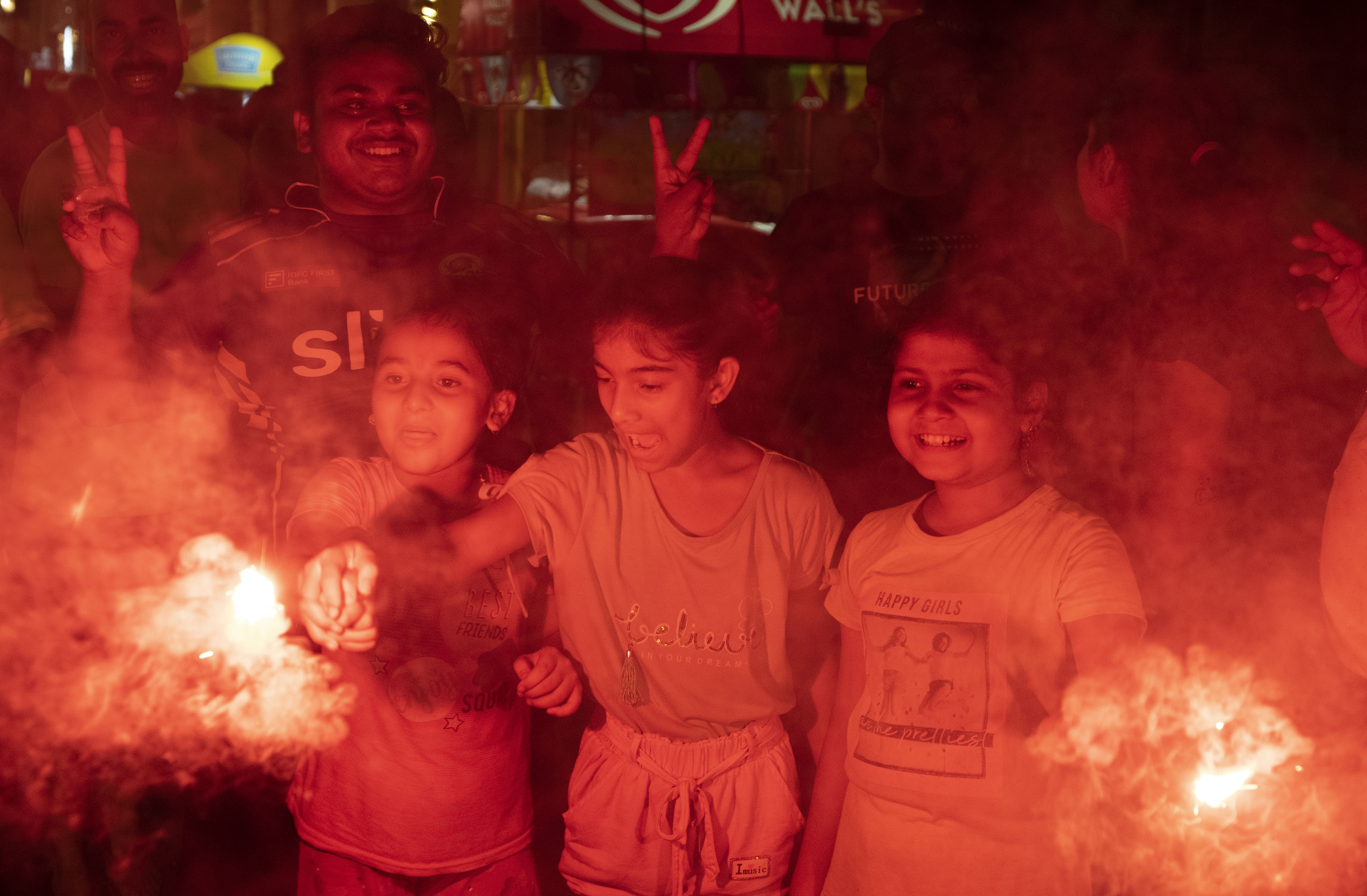 Cricket fans celebrate by lighting firecrackers in Lucknow, capital of northern Indian state of Uttar Pradesh, India, Sunday, June 30
