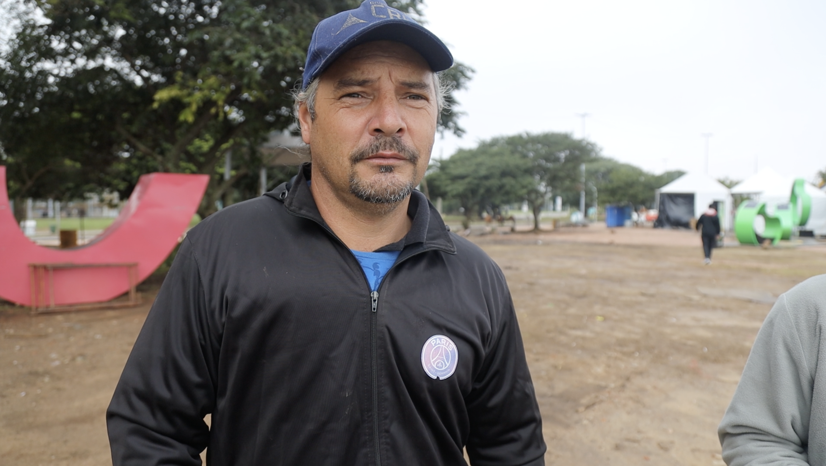 Gelarde Luiz, in a blue ball cap and a black pullover sweater.