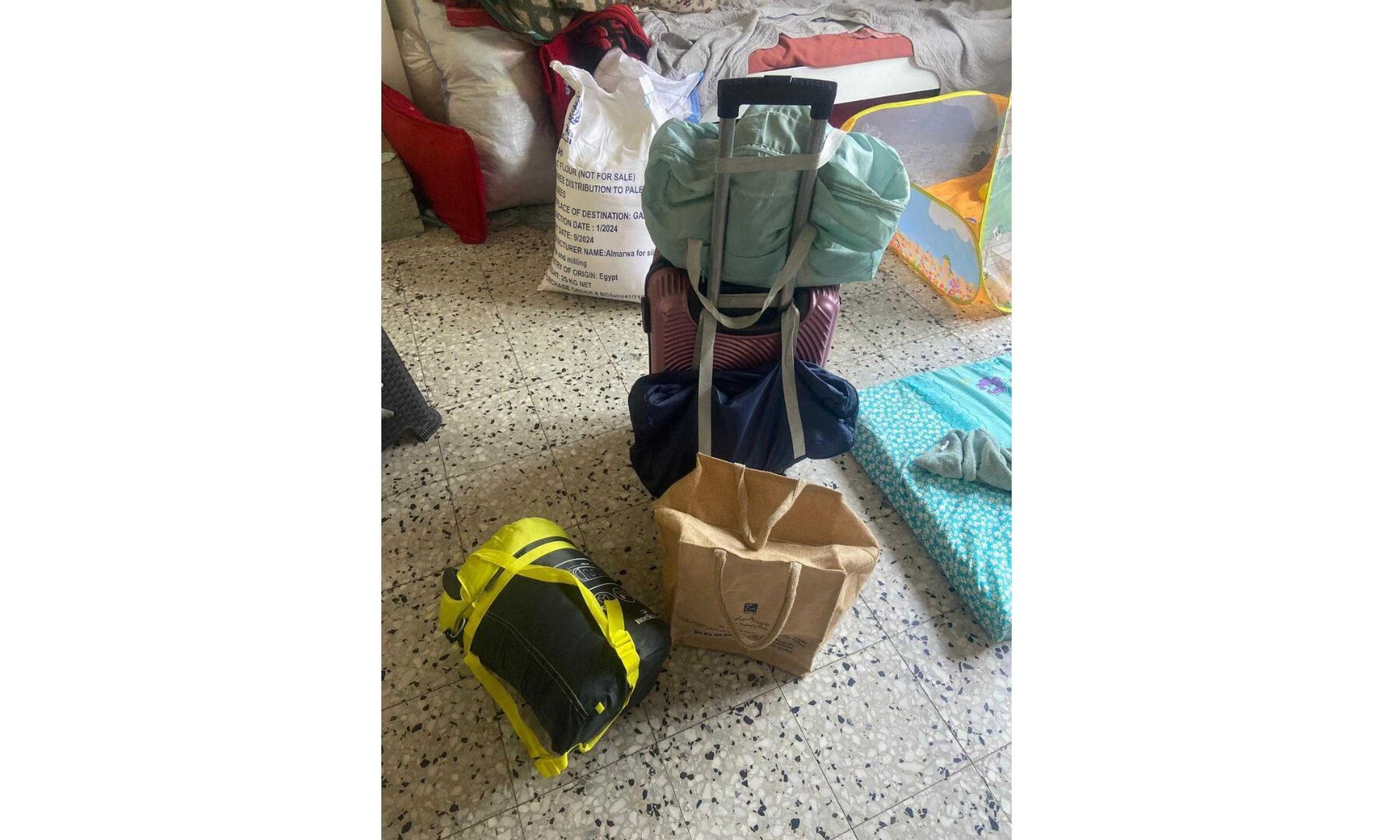 a carryon with three small shoulder bags and back packs around it