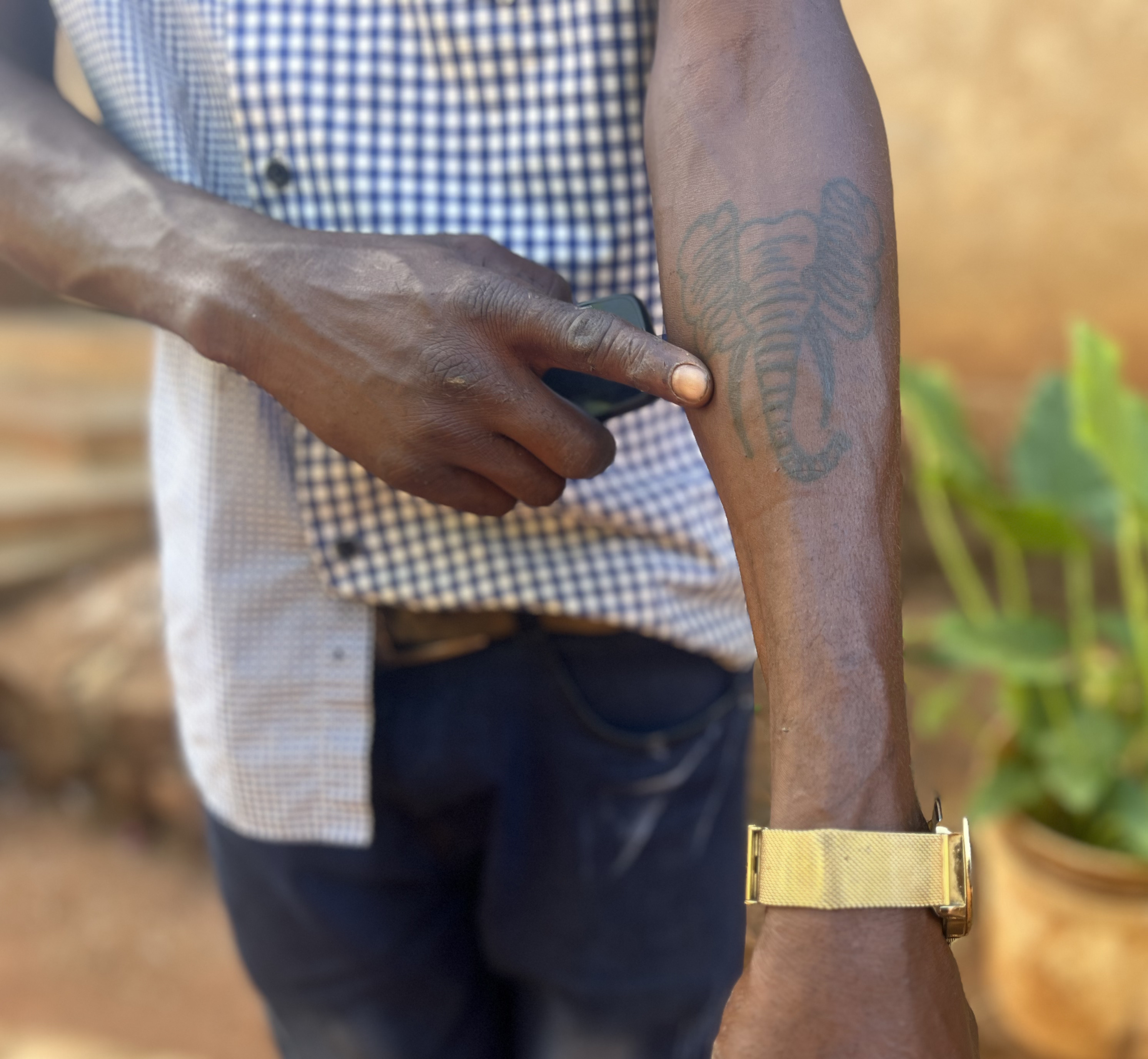 A man shows a tattoo of the elephant that killed his father