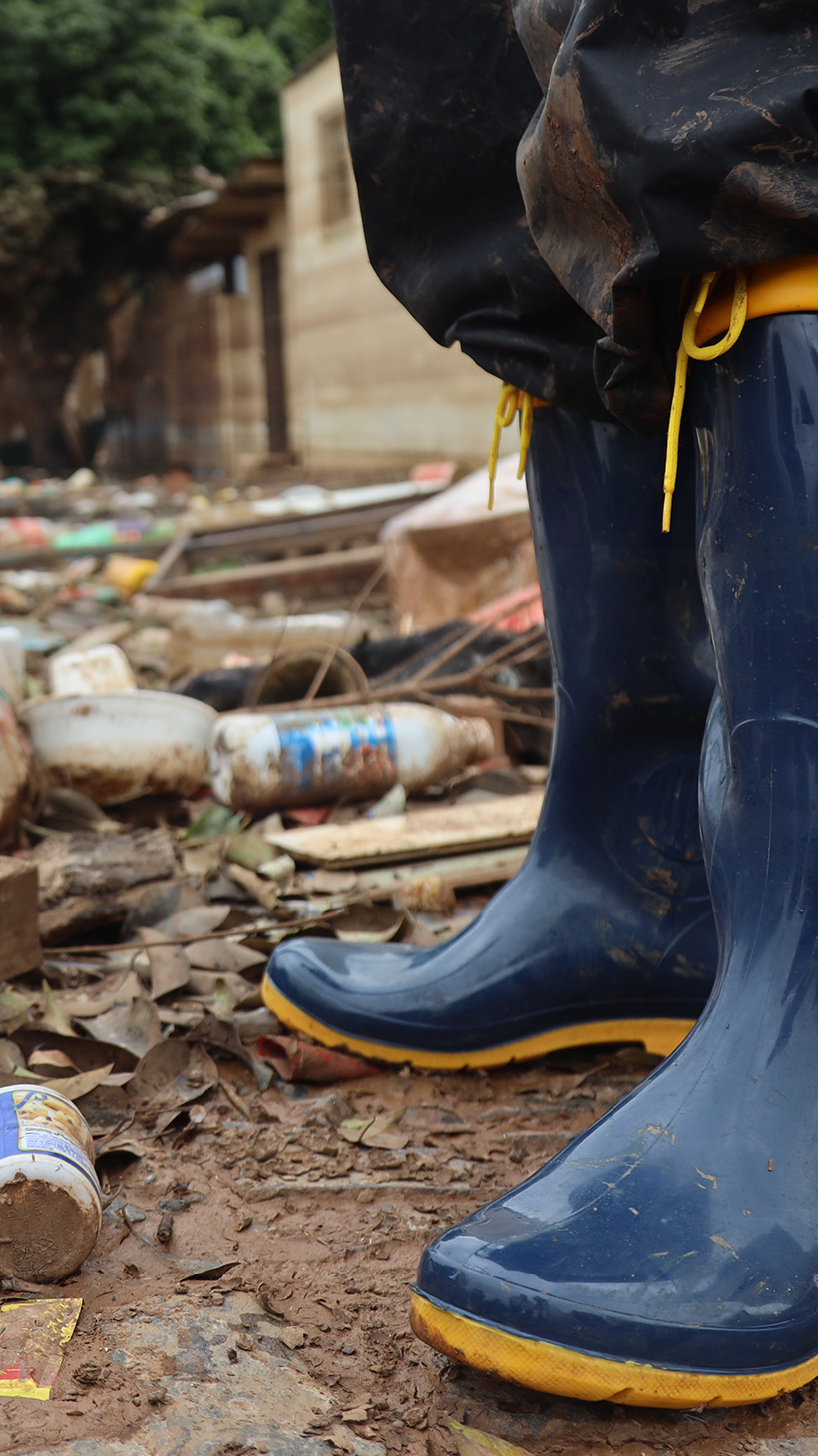 A pair of Wellington rain-boots are seen standing amid the rubble of a flooded street