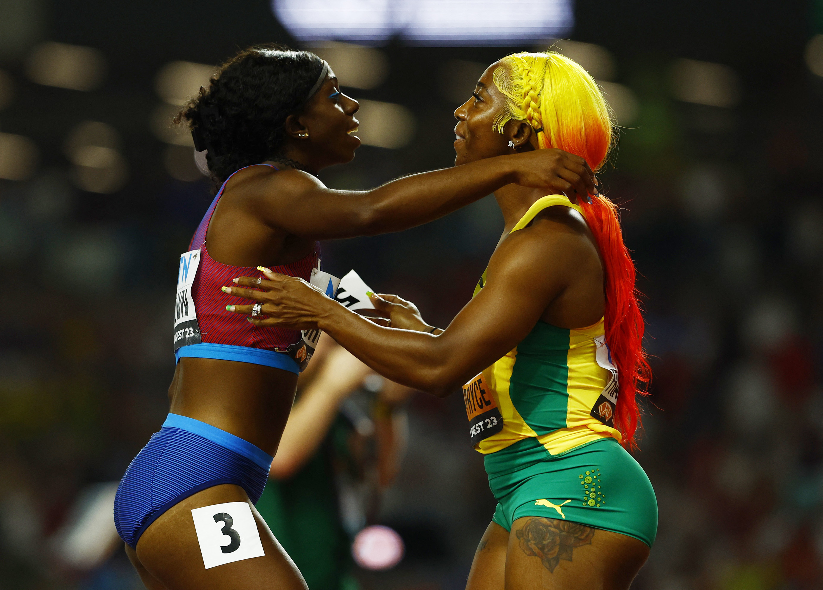 Athletes hug after race.