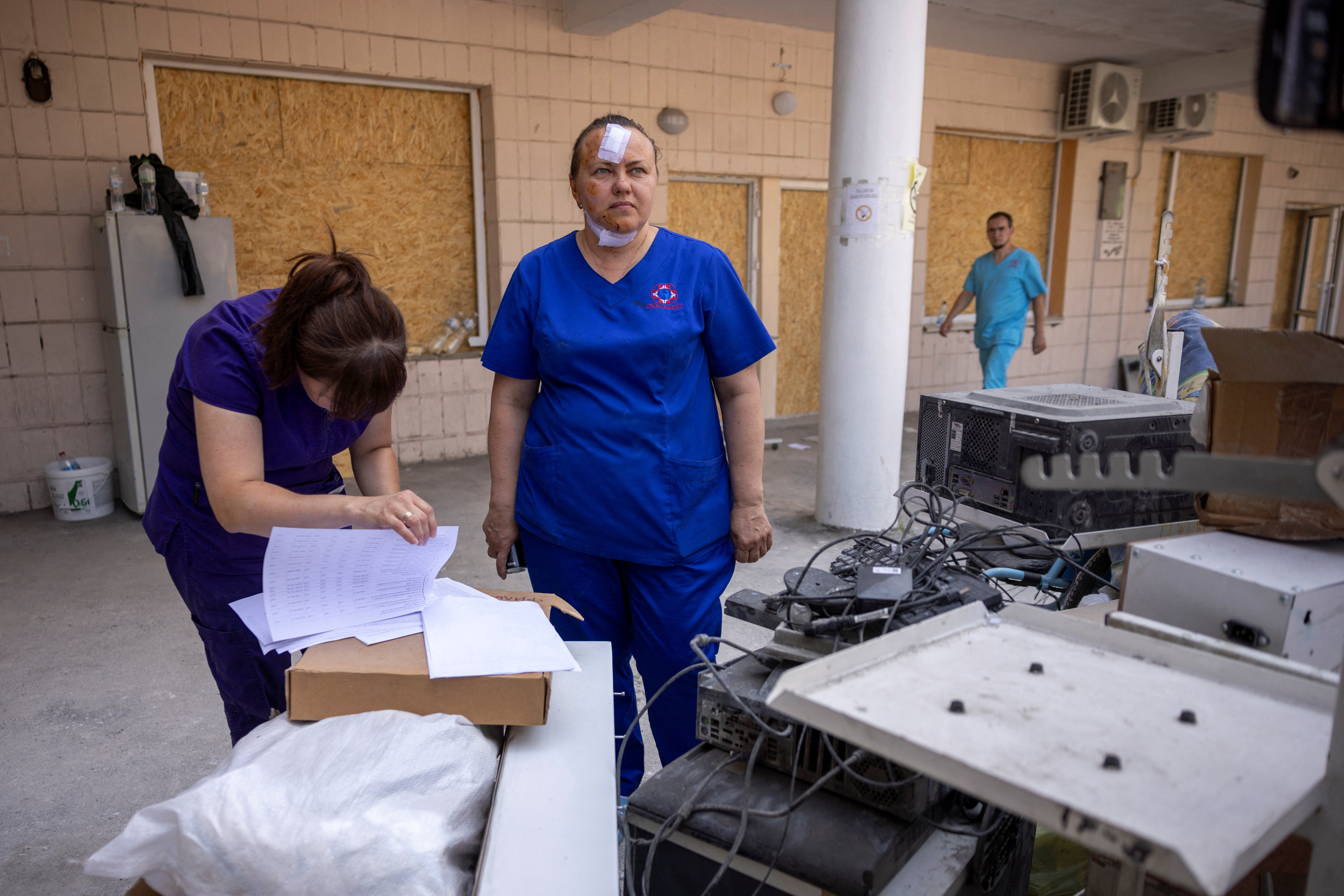 Inna, a nurse who was injured when a Russian missile struck the Okhmatdyt Children's Hospital, stands as she looks for medical equipment to salvage among the debris, amid Russia's attack on Ukraine, in Kyiv, Ukraine July 9, 2024. REUTERS/Thomas Peter