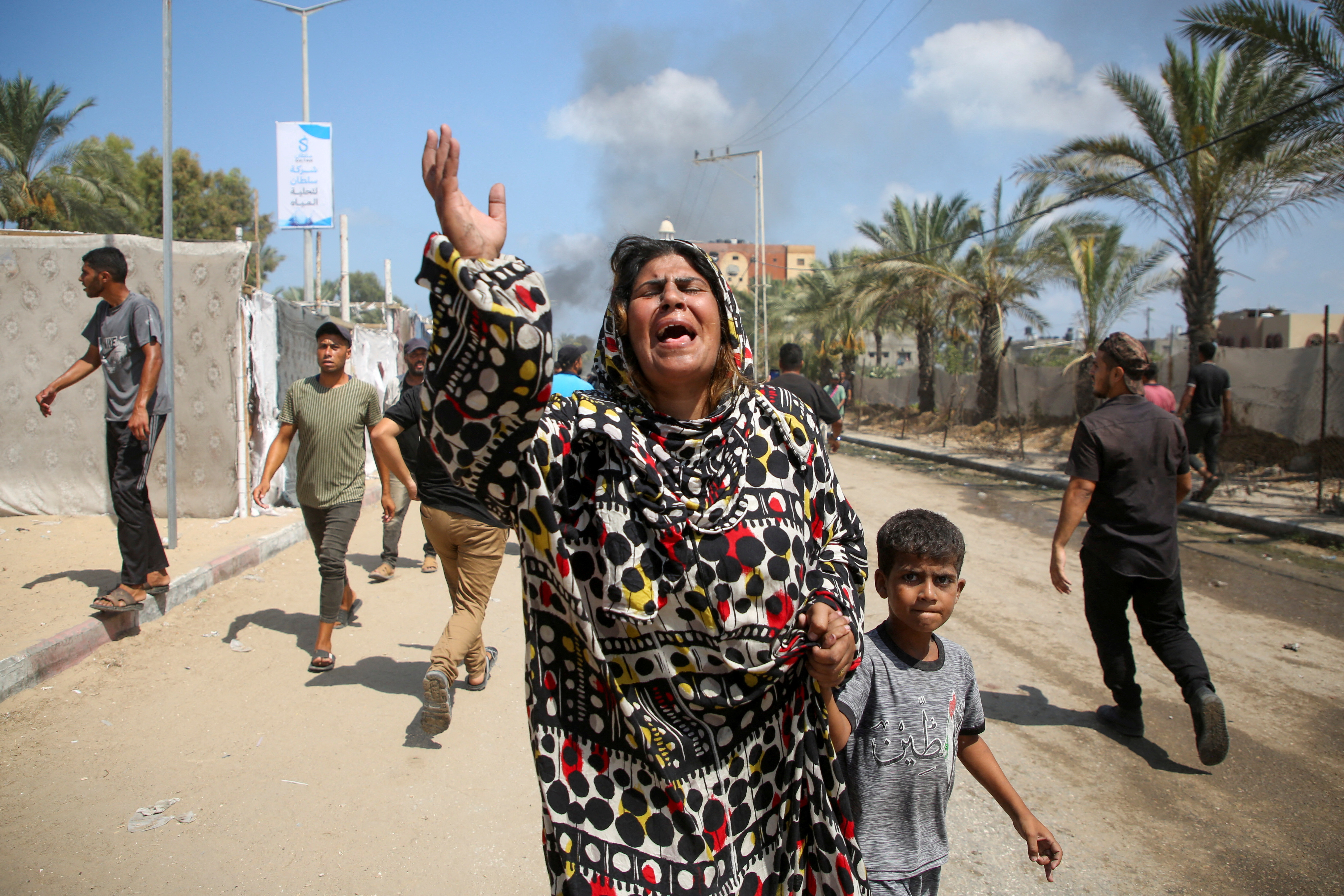 Palestinian woman raises hand in mourning