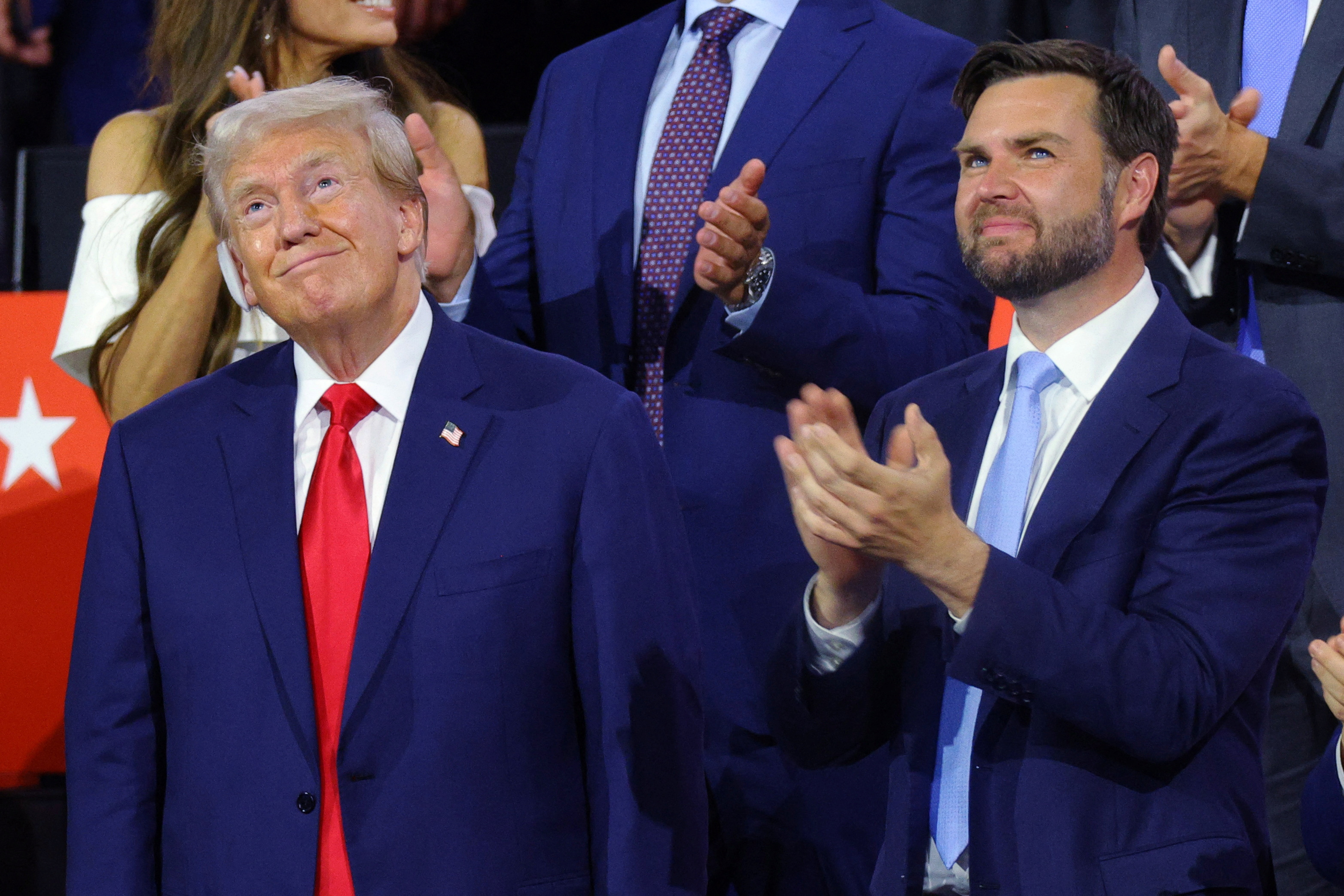 Republican presidential nominee and former U.S. President Donald Trump joins Republican vice presidential nominee J.D. Vance during Day 1 of the Republican National Convention (RNC), at the Fiserv Forum in Milwaukee, Wisconsin