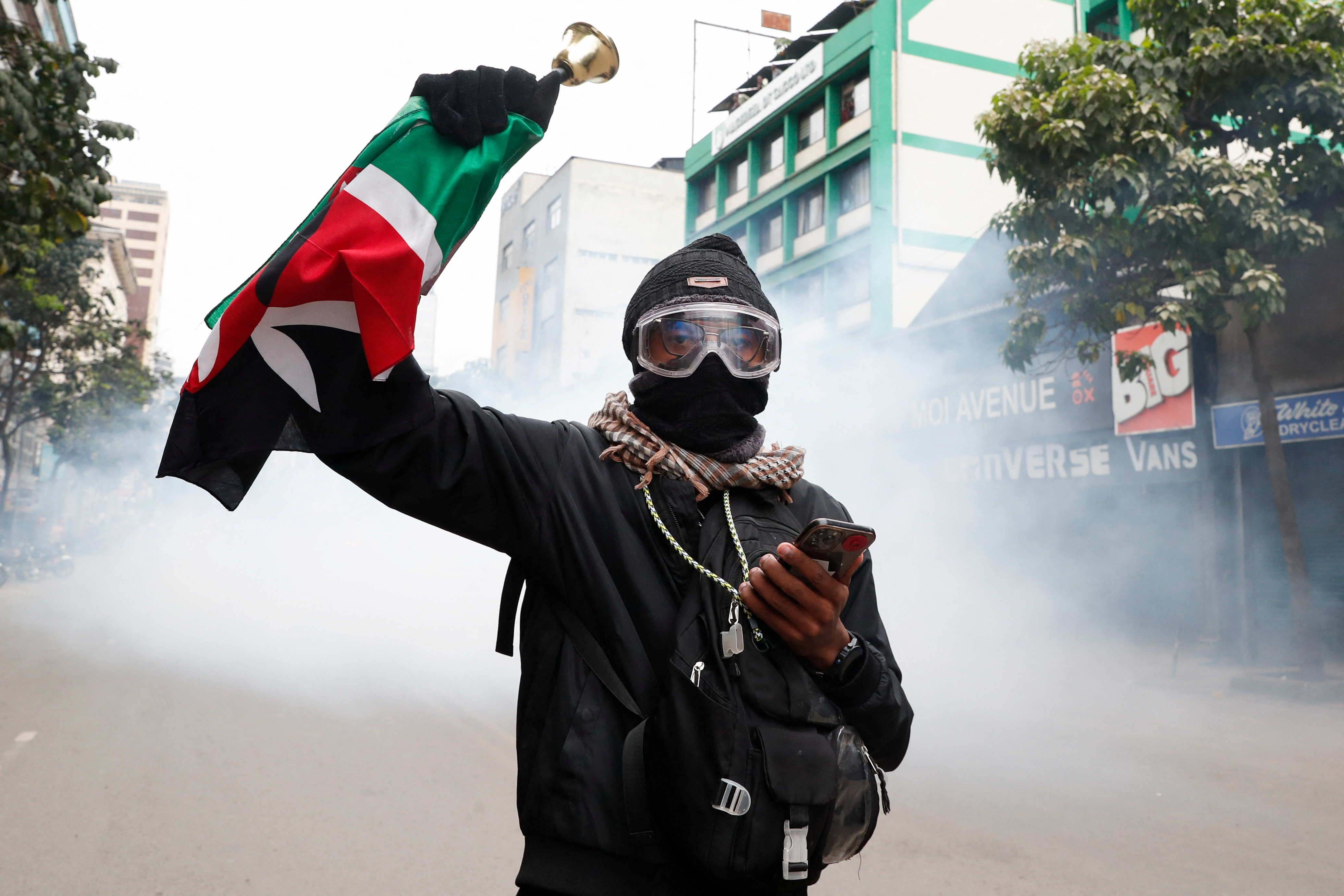 Protesters hold flags as they participate in an anti-government demonstration