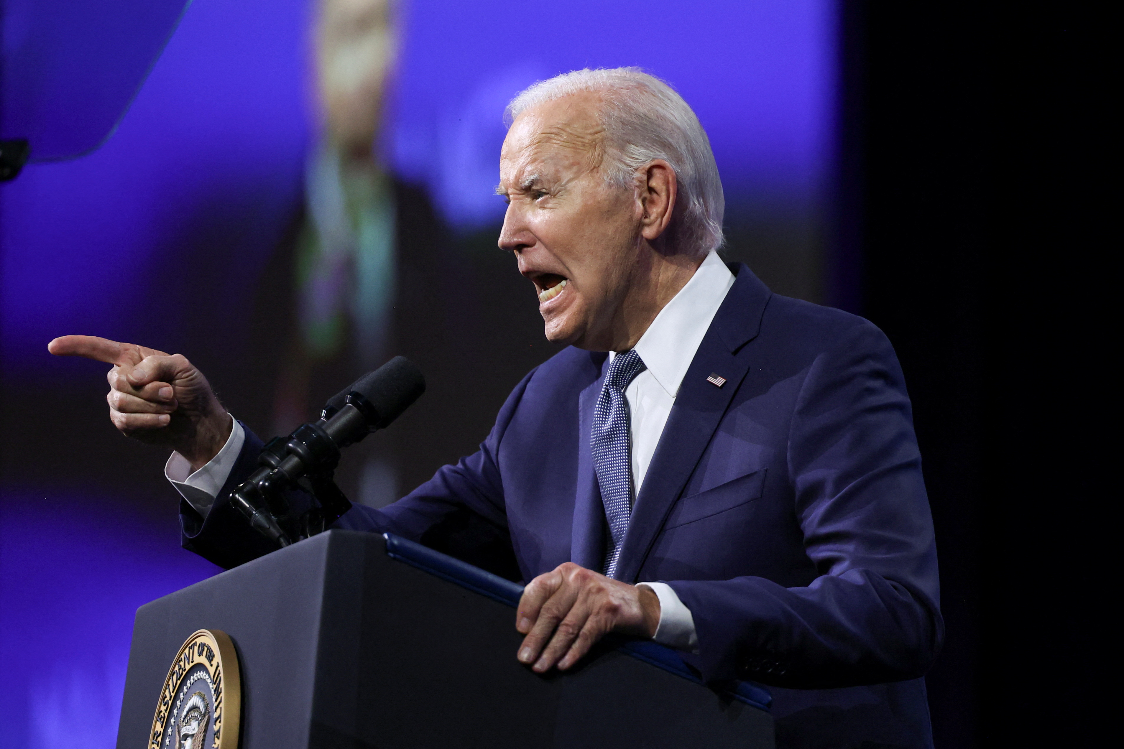Joe Biden speaks at a podium at the Las Vegas NAACP convention.