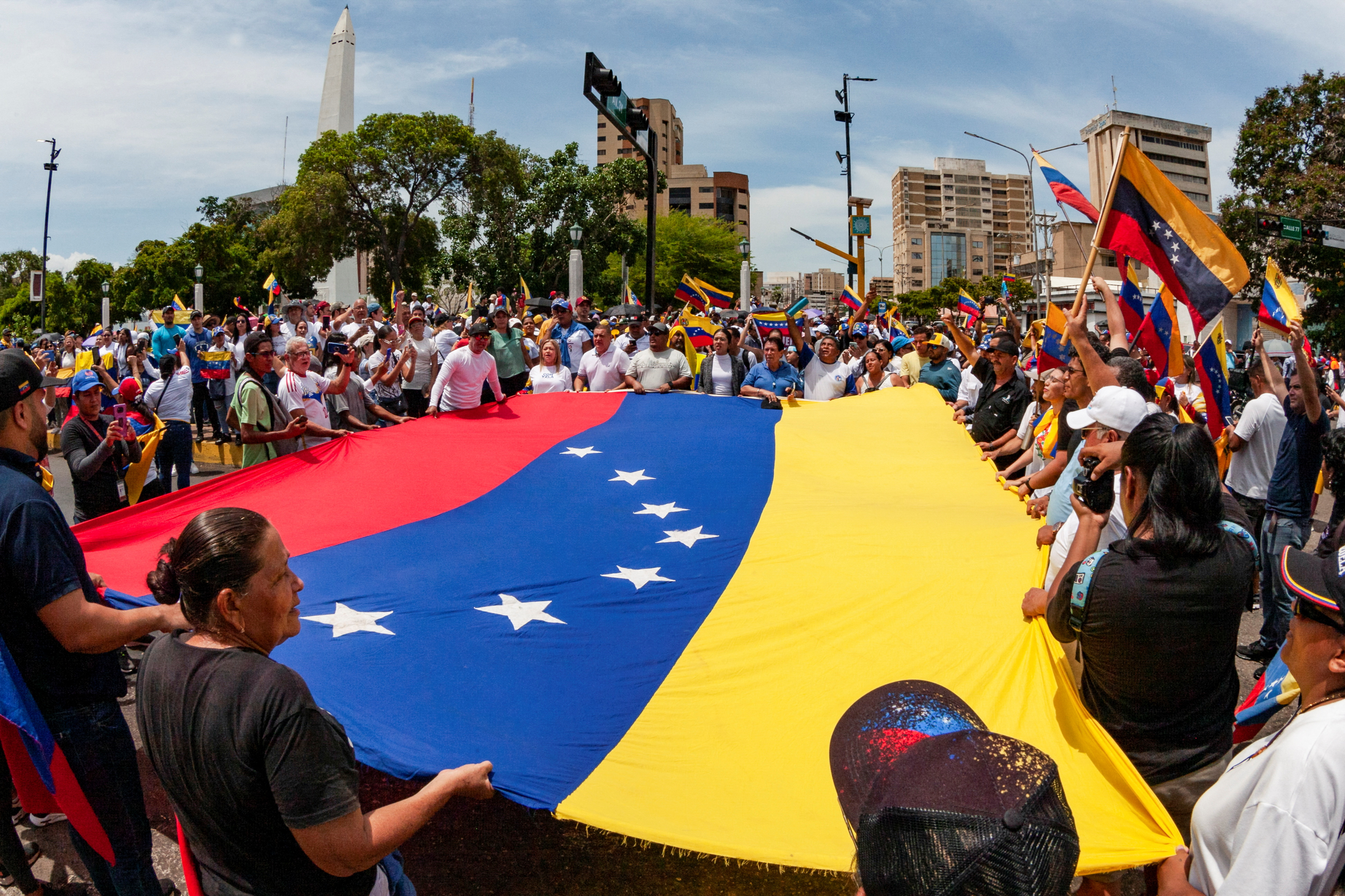 People carry Venezuela's flag as they protest election results