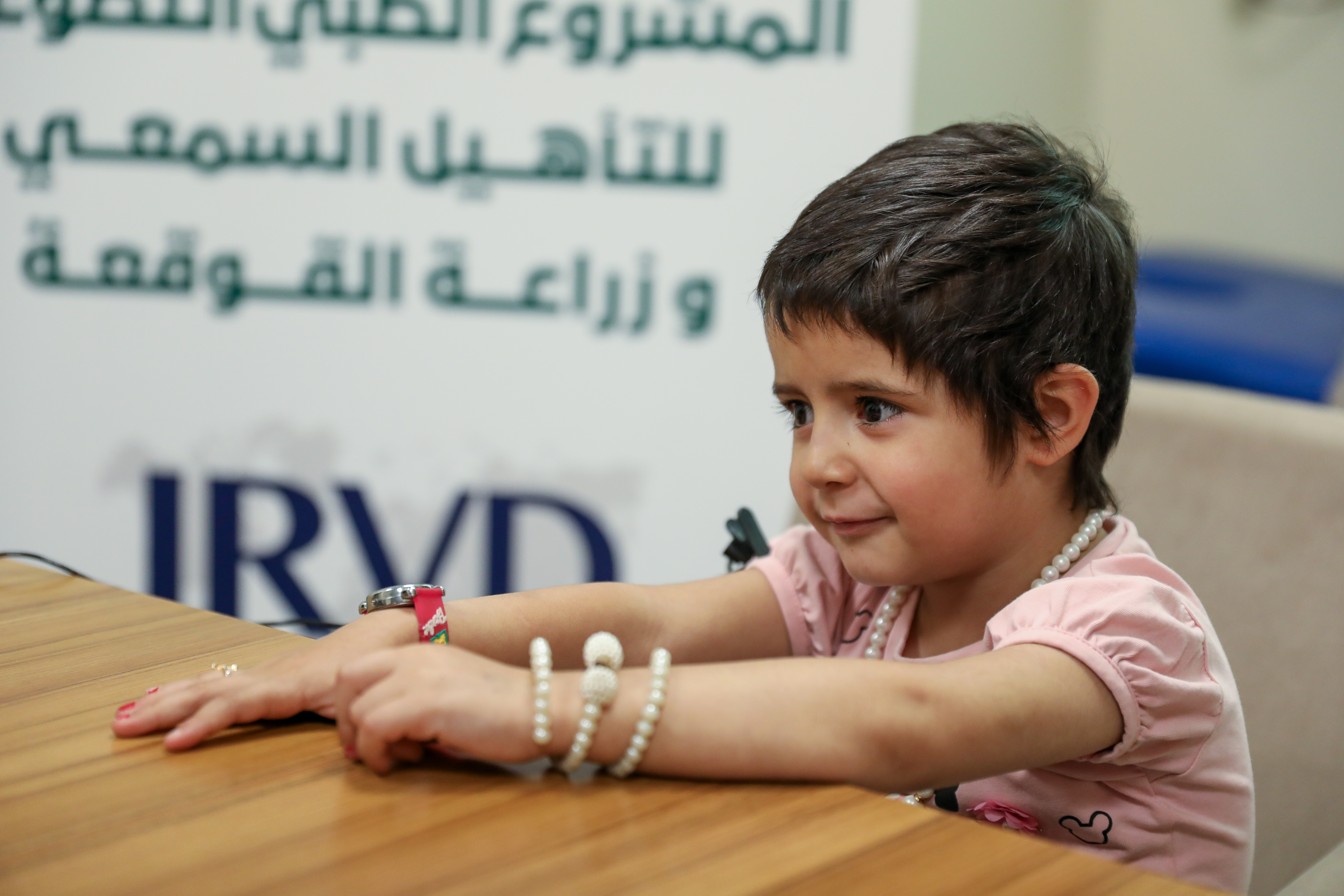 Celine with her hands on a table