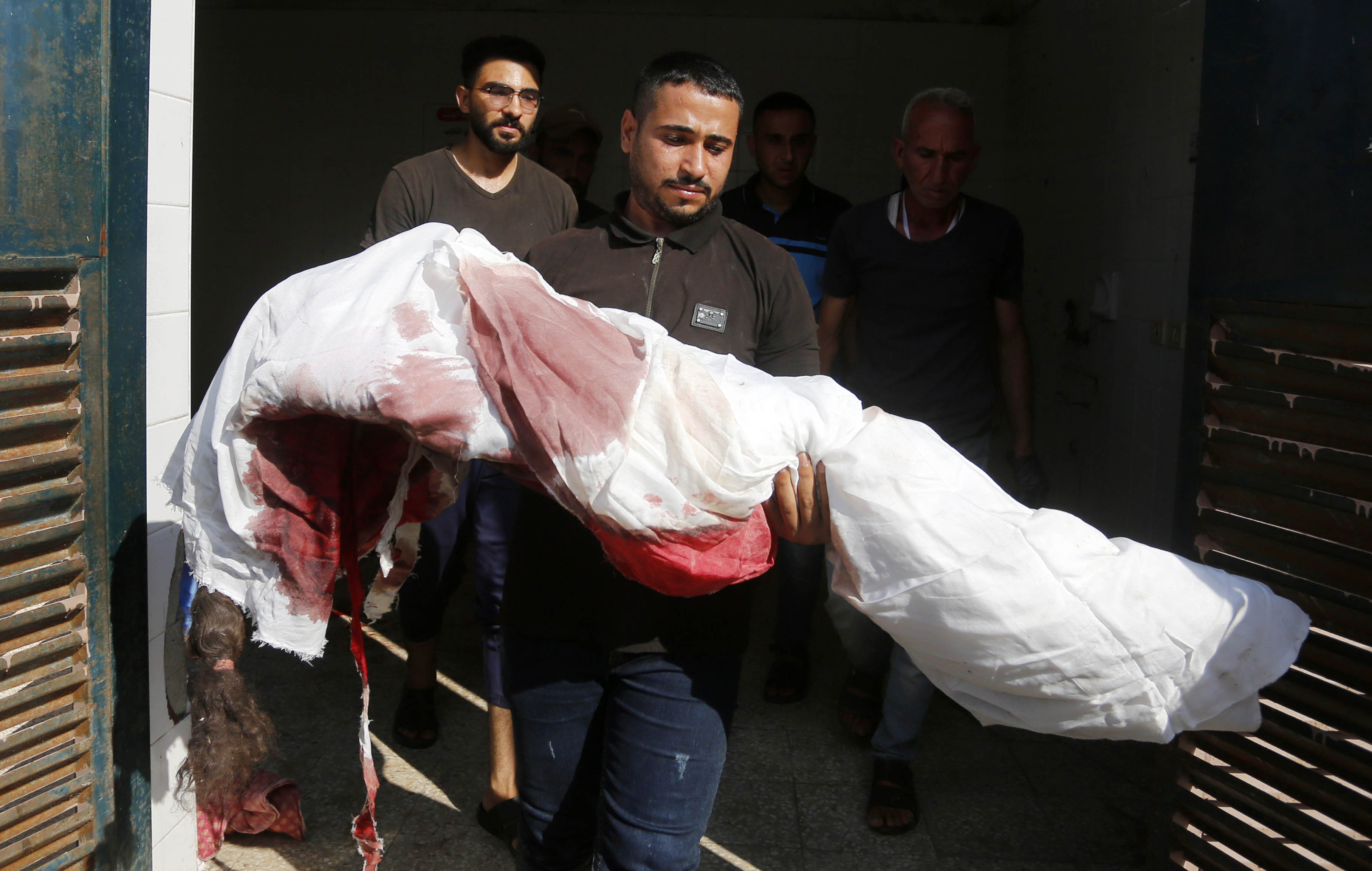 Bodies of the members of al-Muharib family, who were killed during an Israeli attack on Nuseirat refugee camp, are brought to the Aqsa Martyrs Hospital