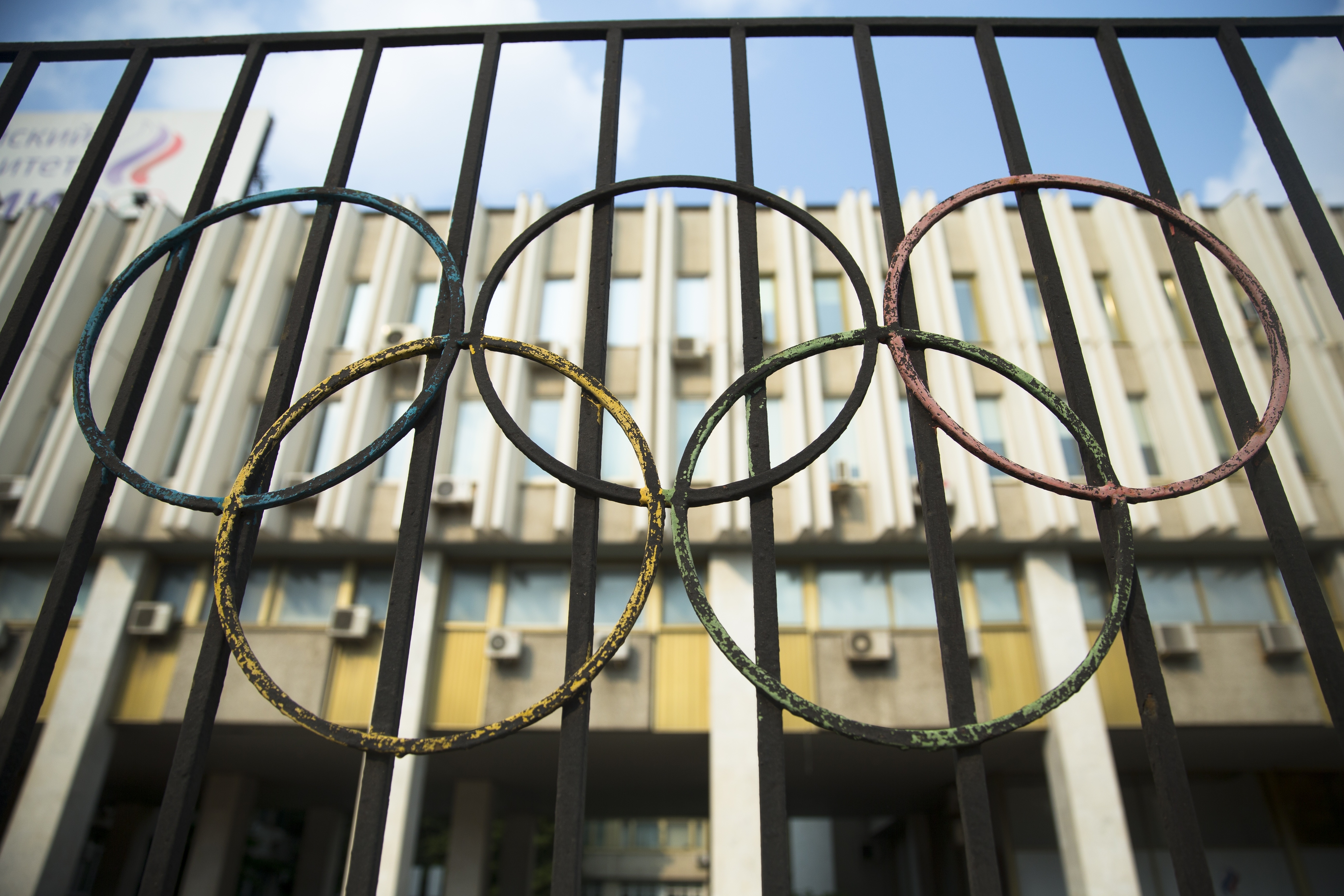 The Olympics rings are seen on a fence in front of the Russian Olympic Committee building in Moscow, Russia, Sunday, July 24, 2016. The IOC has decided against a complete ban on Russian athletes from the Olympics in Rio de Janeiro. The International Olympic Committee says it is leaving it up to global federations to decide which Russian athletes to accept in their sports. (AP Photo/Pavel Golovkin)