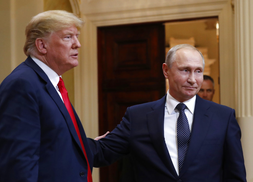 U.S. President Donald Trump, left, and Russian President Vladimir Putin leave a press conference after their meeting at the Presidential Palace in Helsinki, Finland, Monday, July 16, 2018. (AP Photo/Pablo Martinez Monsivais)