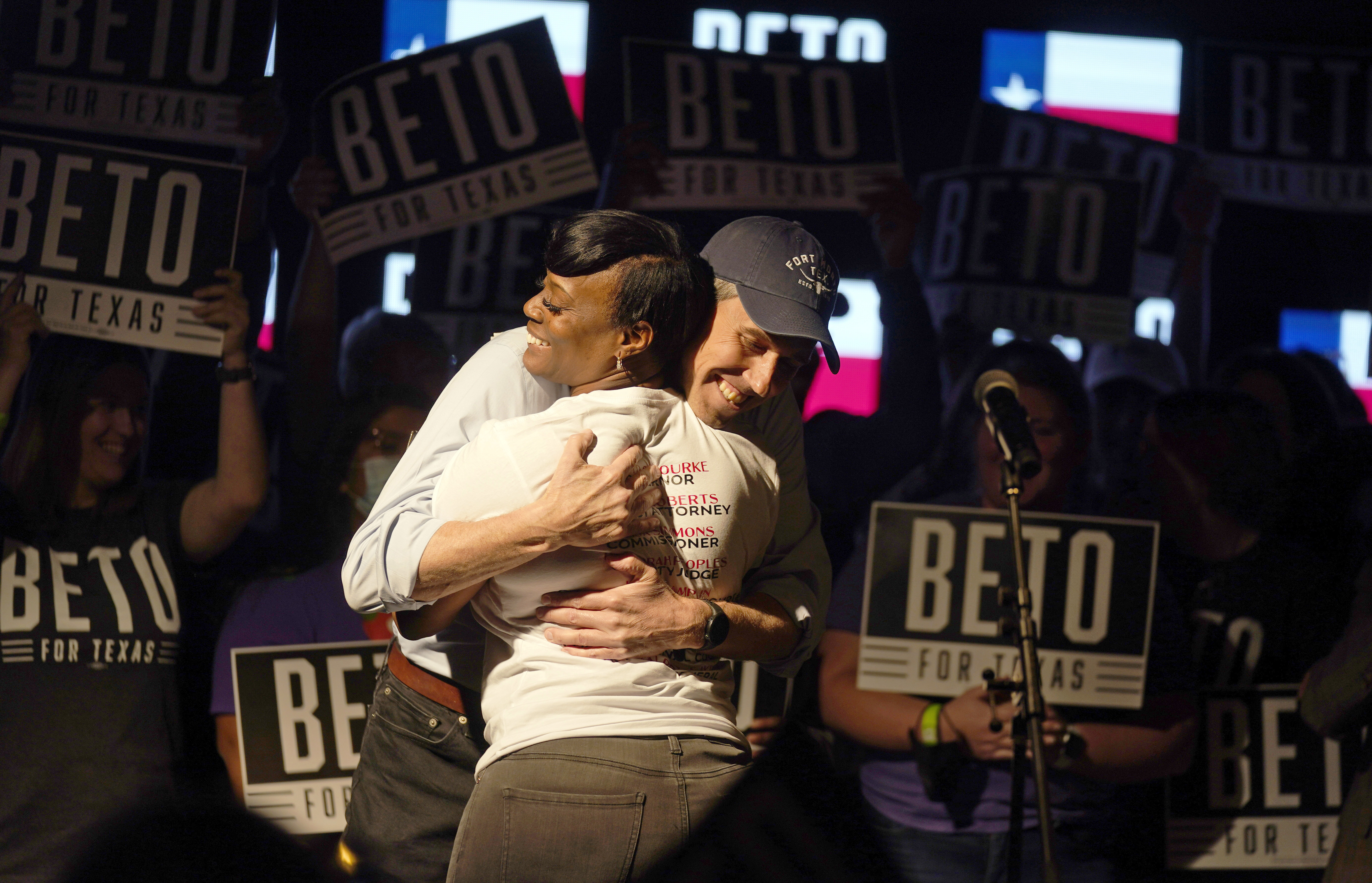 Beto O'Rourke hugs Crystal Mason on stage.