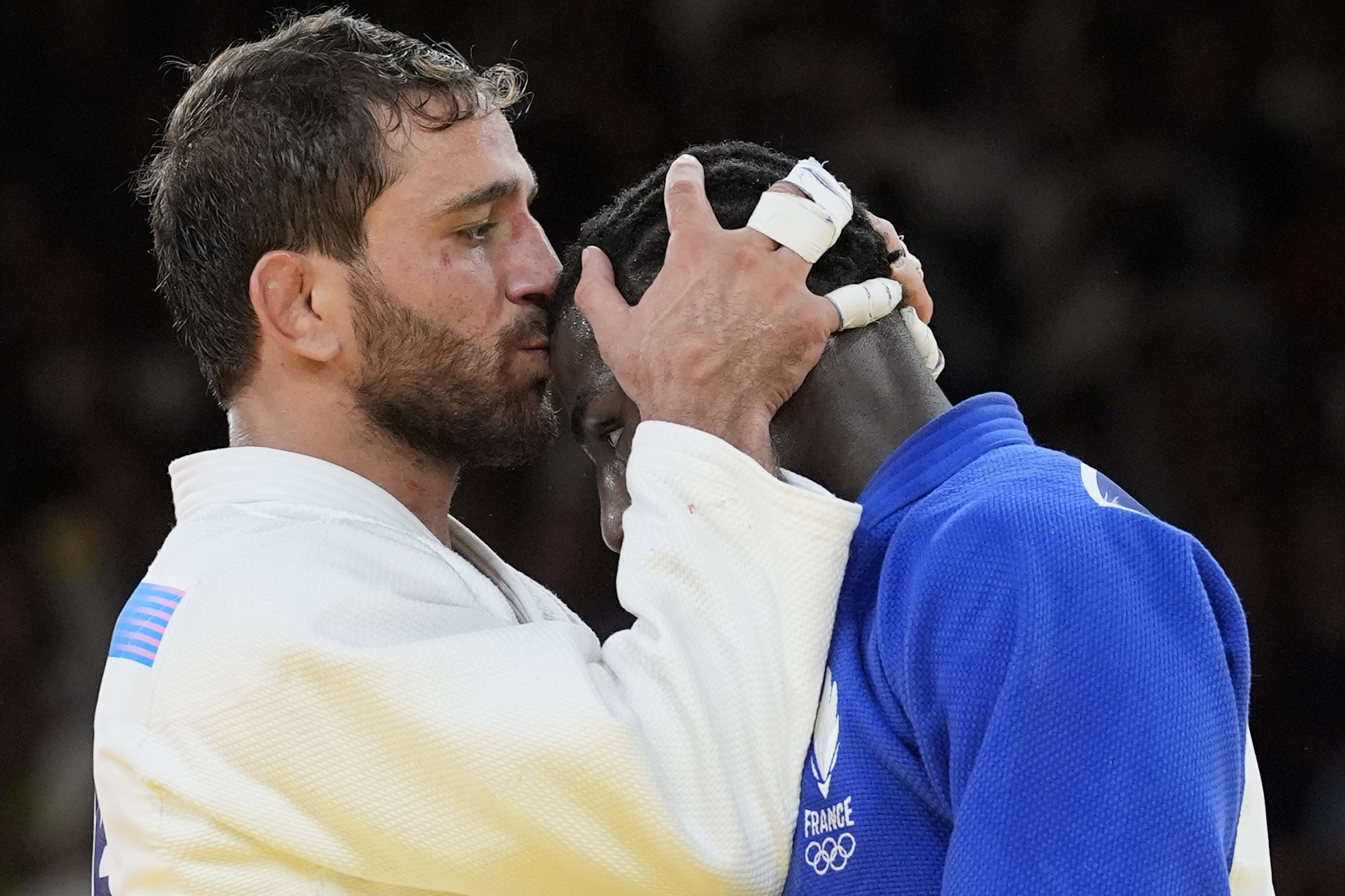 Azerbaijan's Hidayet Heydarov celebrates after defeating France's Joan-Benjamin Gaba, right, during their men -73 kg final match in team judo competition at Champ-de-Mars Arena during the 2024 Summer Olympics, Monday, July 29, 2024, in Paris, France. (AP Photo/Eugene Hoshiko)